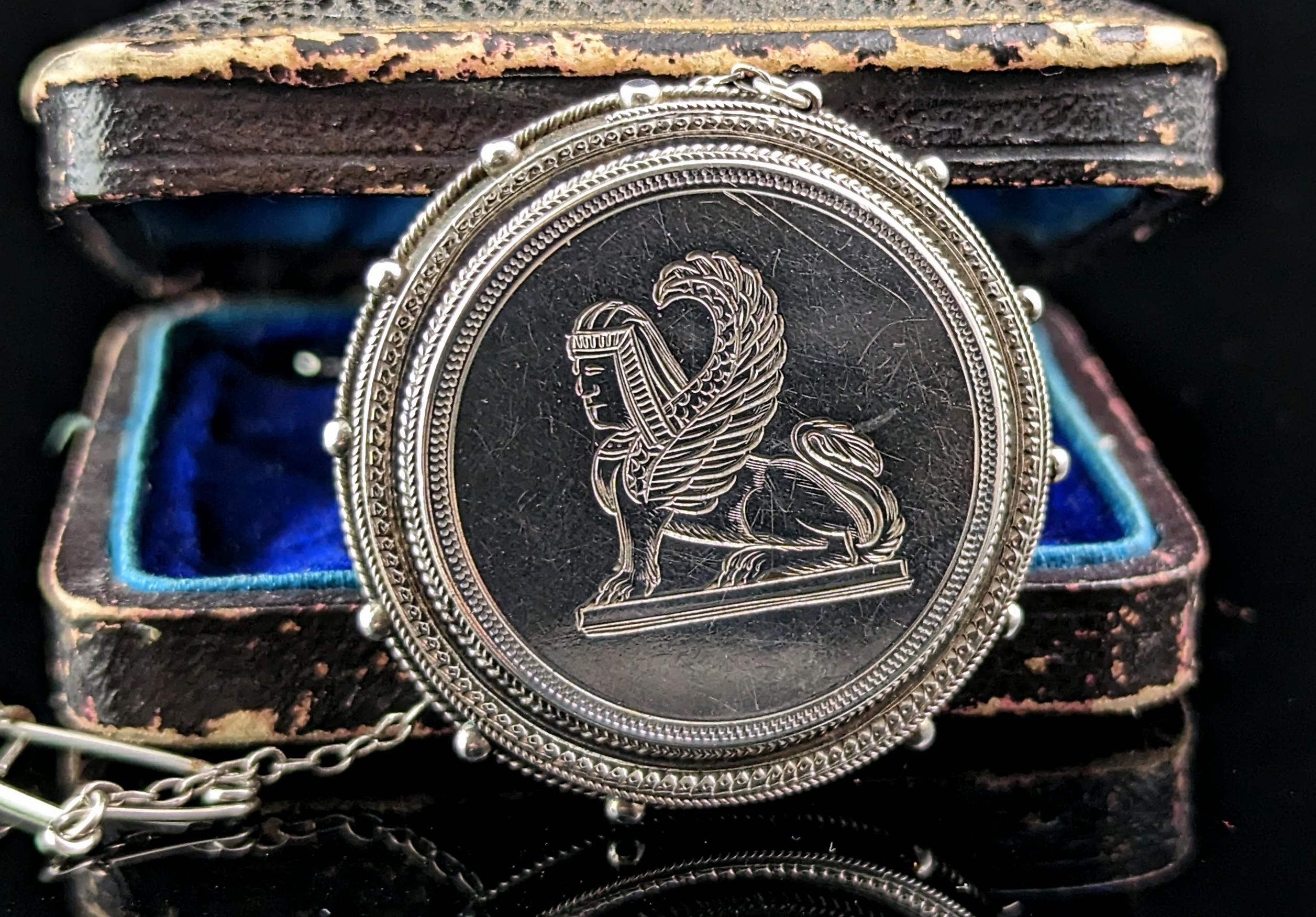 A scarce and unusual antique Victorian era brooch.

An Assyrian revival piece, probably obtained from global travels this brooch depicts a Lamassu.

A Lamassu was an ancient diety or originally a goddess of protection, usually a combination of;