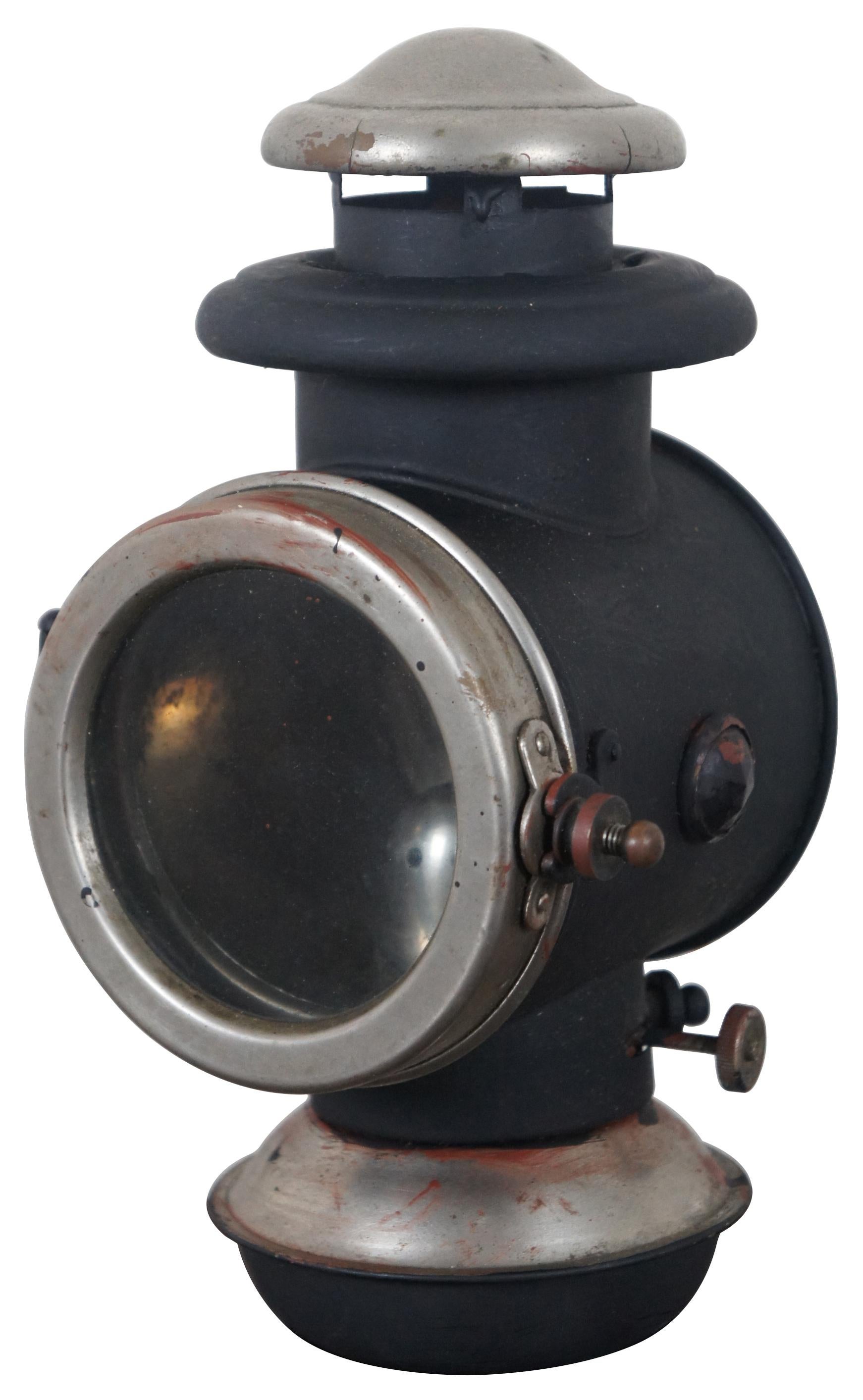 Antique early 20th century oil lit carriage lantern or automobile headlight.
  