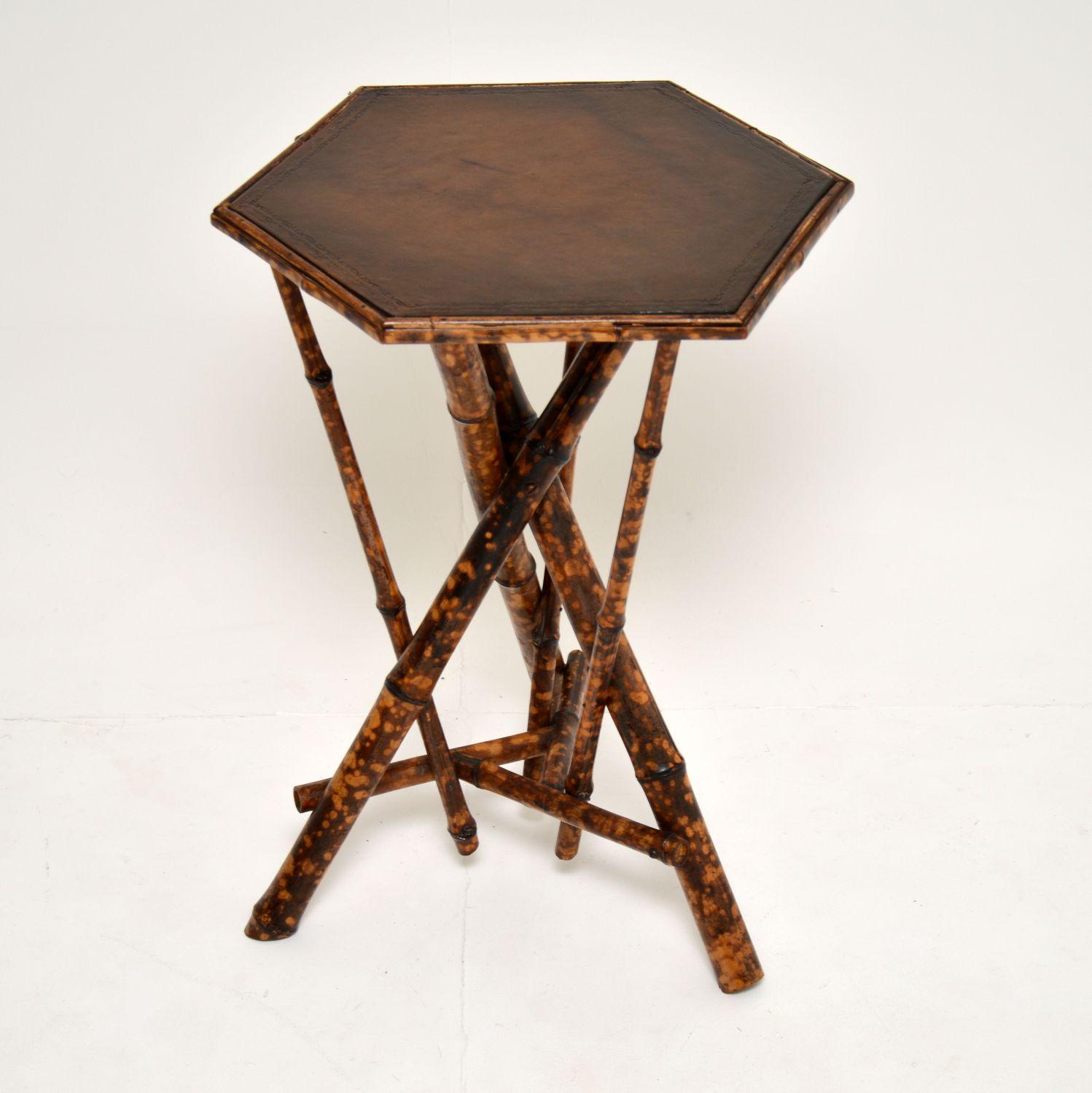 A gorgeous antique Victorian side table, made from thick bamboo and with an inset leather top. This dates from circa 1860-1880 period.

It is in amazing condition for its age, the bamboo base has been newly polished. The inset leather top has also