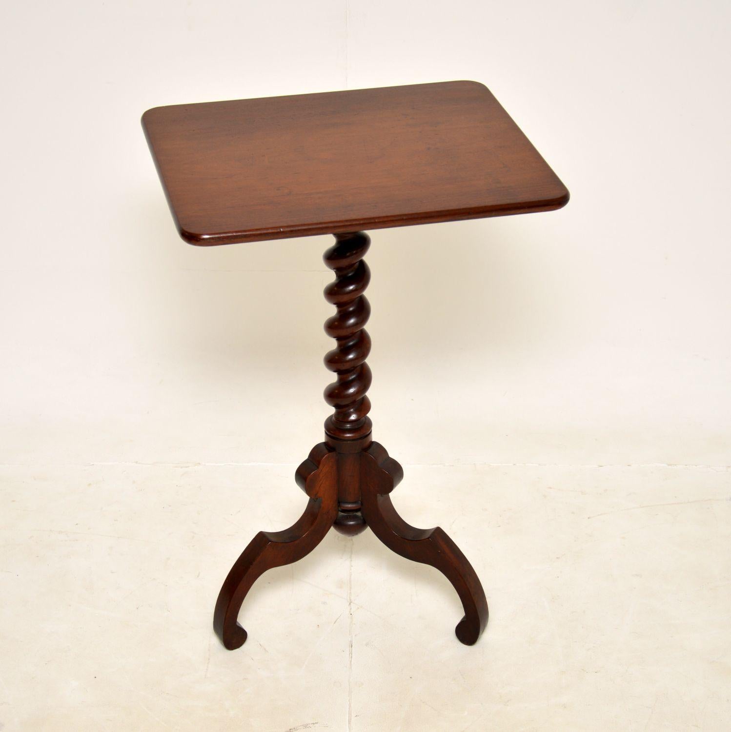 A wonderful antique Victorian occasional side table. This was made in England, it dates from around the 1850-1870 period.

It is of superb quality, the rectangular top is supported by a barley twist column, which sits on a carved tripod base.

We
