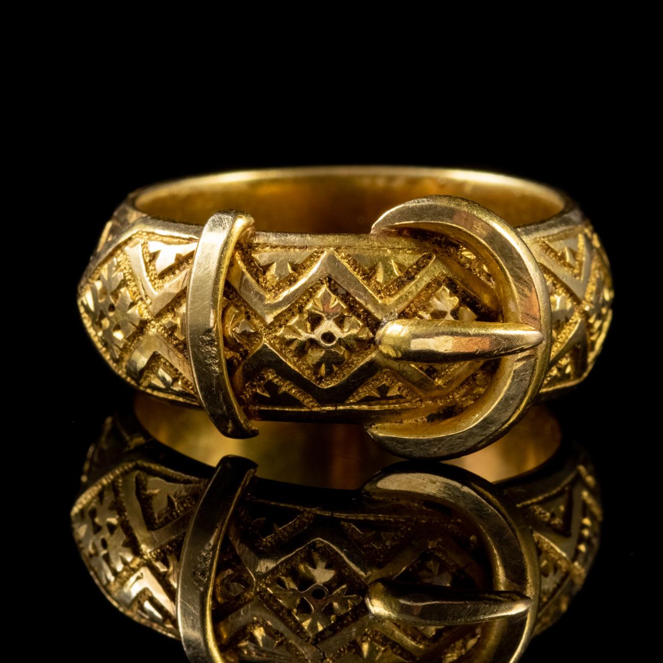 This fabulous Antique Victorian ring has been modelled in 18ct Yellow Gold to form the shape of a belt and buckle with beautiful and intricate engravings all the way around. It has an impressive weight due to its design and weighs a staggering 8.5