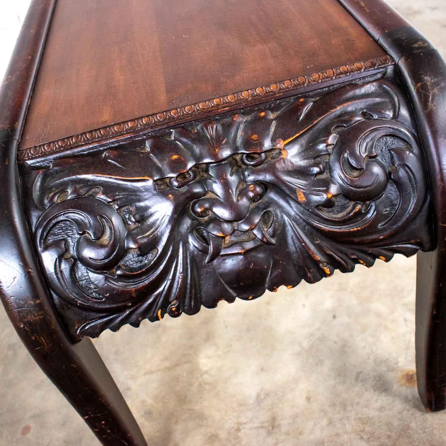 Fantastic antique hand carved North Wind style mythical face bench or table comprised of rich walnut and mixed woods. It is in beautiful vintage condition. It does have nicks and dings and signs of age, but we call that patina and think it gives