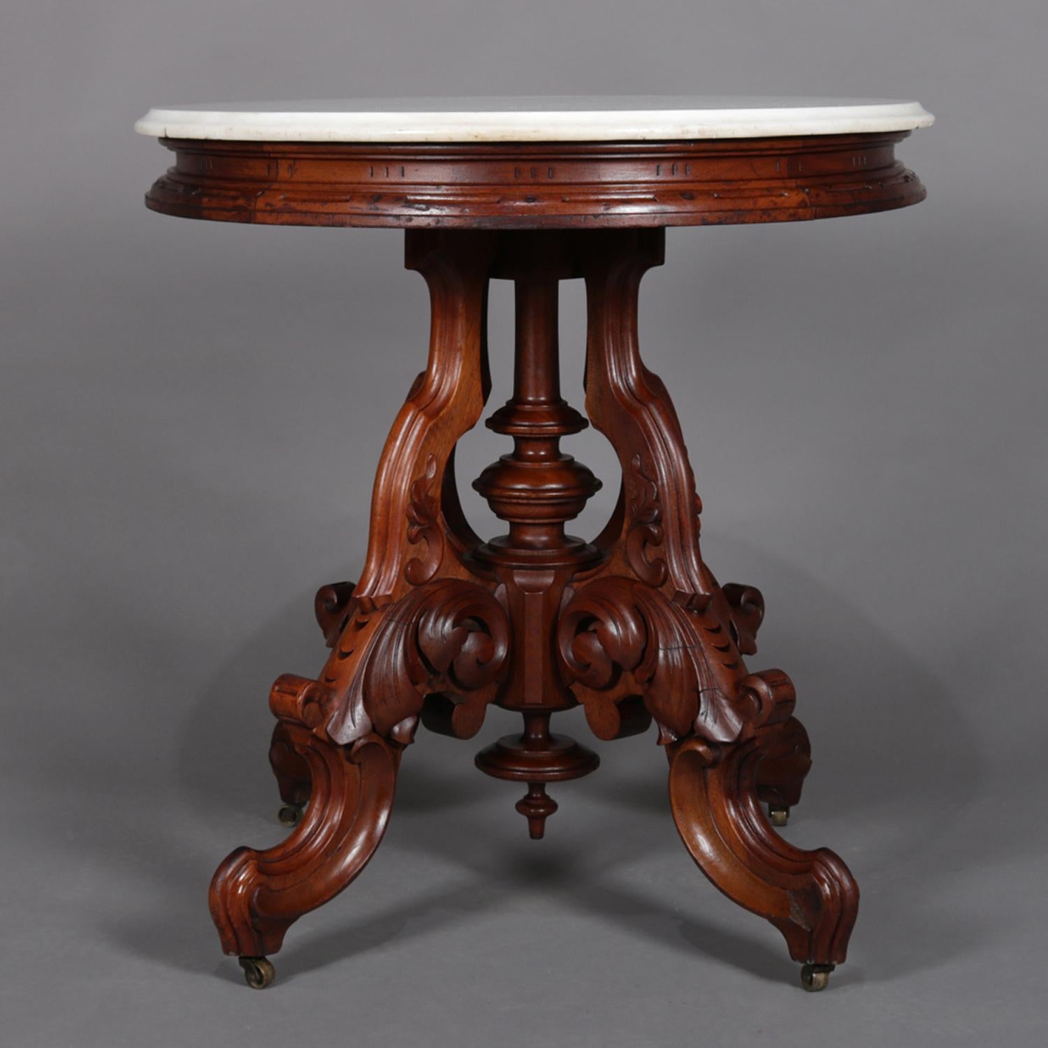 An antique Victorian center table by Berkey & Gay features beveled marble top surmounting walnut base with turned center column and carved acanthus and scroll form legs with casters, circa 1890.

***DELIVERY NOTICE – Due to COVID-19 we are employing