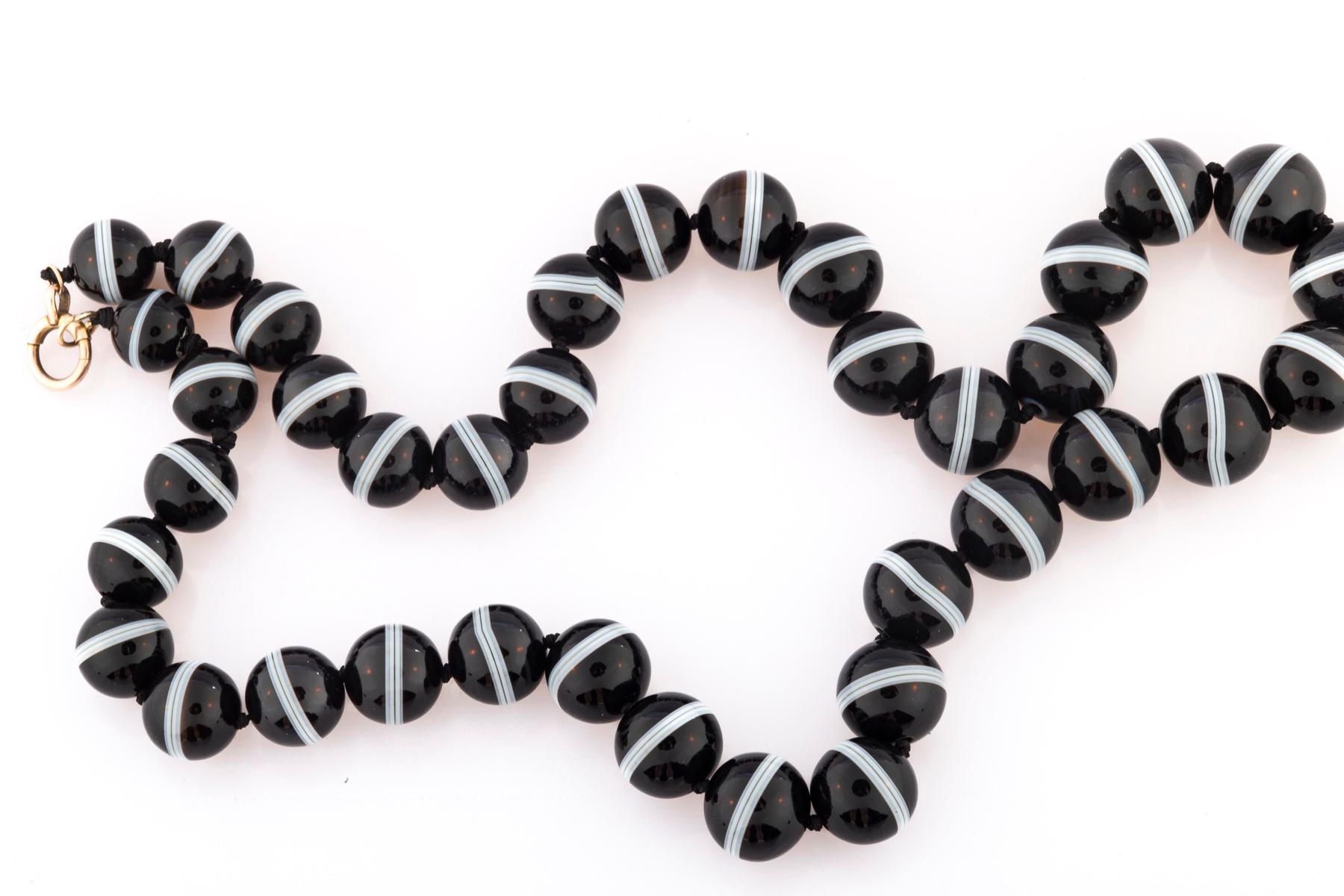 I offer the best Victorian Banded Agate Necklace I have had. I use hyperbole because it is warranted. The necklace is an unusual 25 inches in length. It has been restrung and knotted with all the original agate for your security. The agates graduate