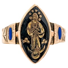 Ancienne bague victorienne en or jaune avec saint religieux en émail noir