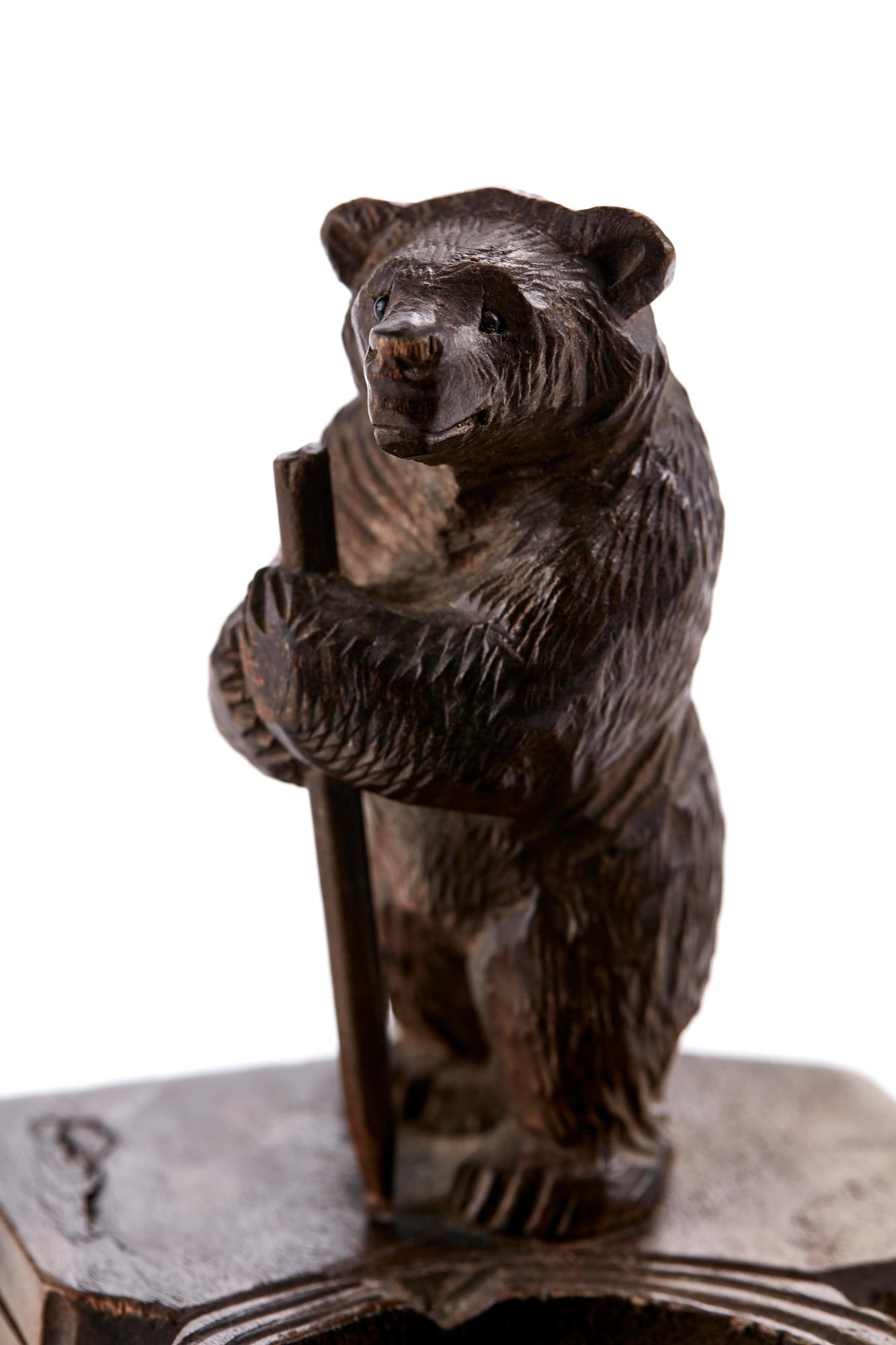 Antique Victorian Black Forest carved bear match stand having a well carved standing bear next to a match box holder and an ashtray.

In lovely original condition.

Measures: H 10.5cm
W 11cm
D 9cm
Date 1880.
 