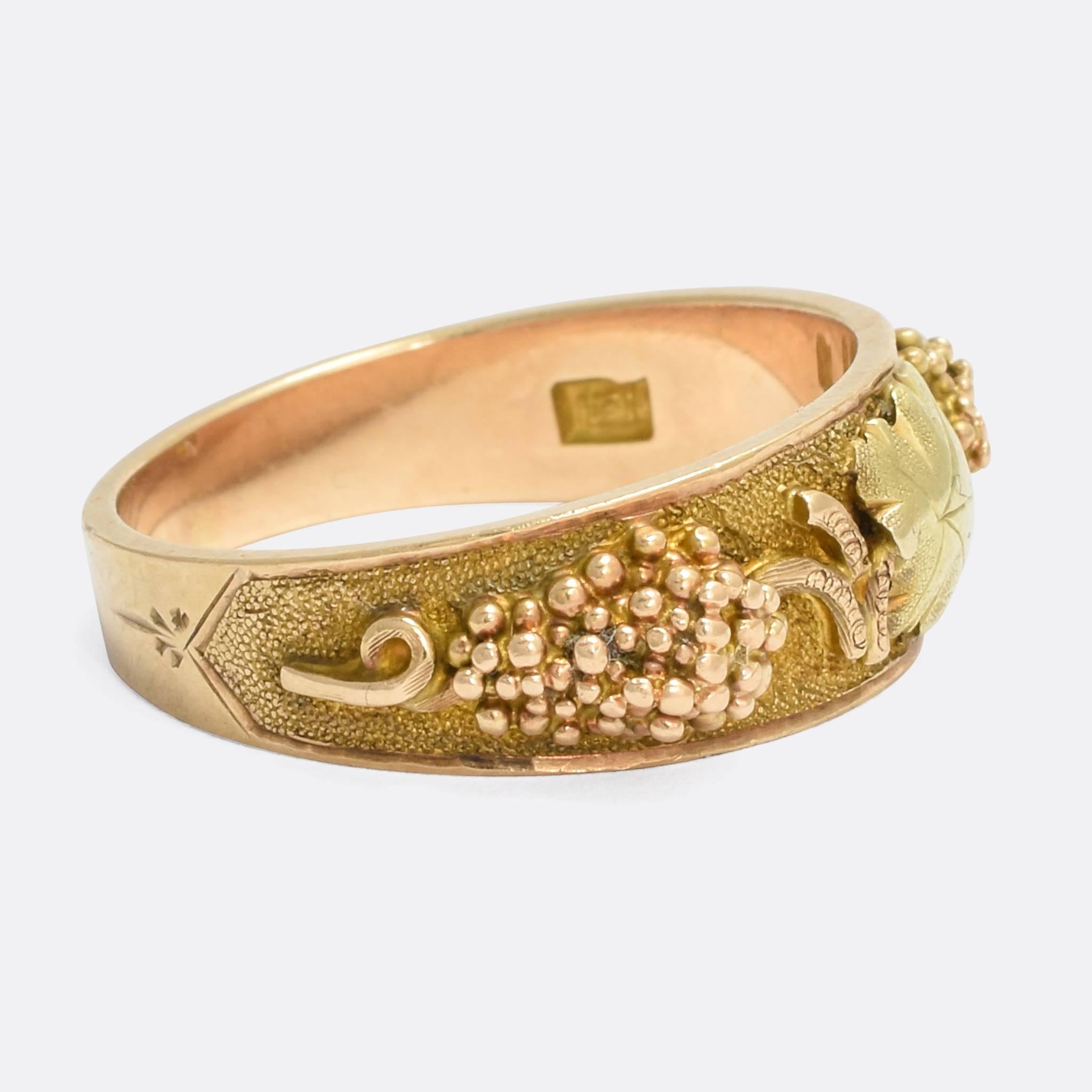 A substantial antique Black Hills Gold ring dating from the Victorian period. It's modelled in 14 karat gold throughout, and the head features the iconic green gold leaf motif, while the shoulders feature grape bunches and vines - the backdrop is