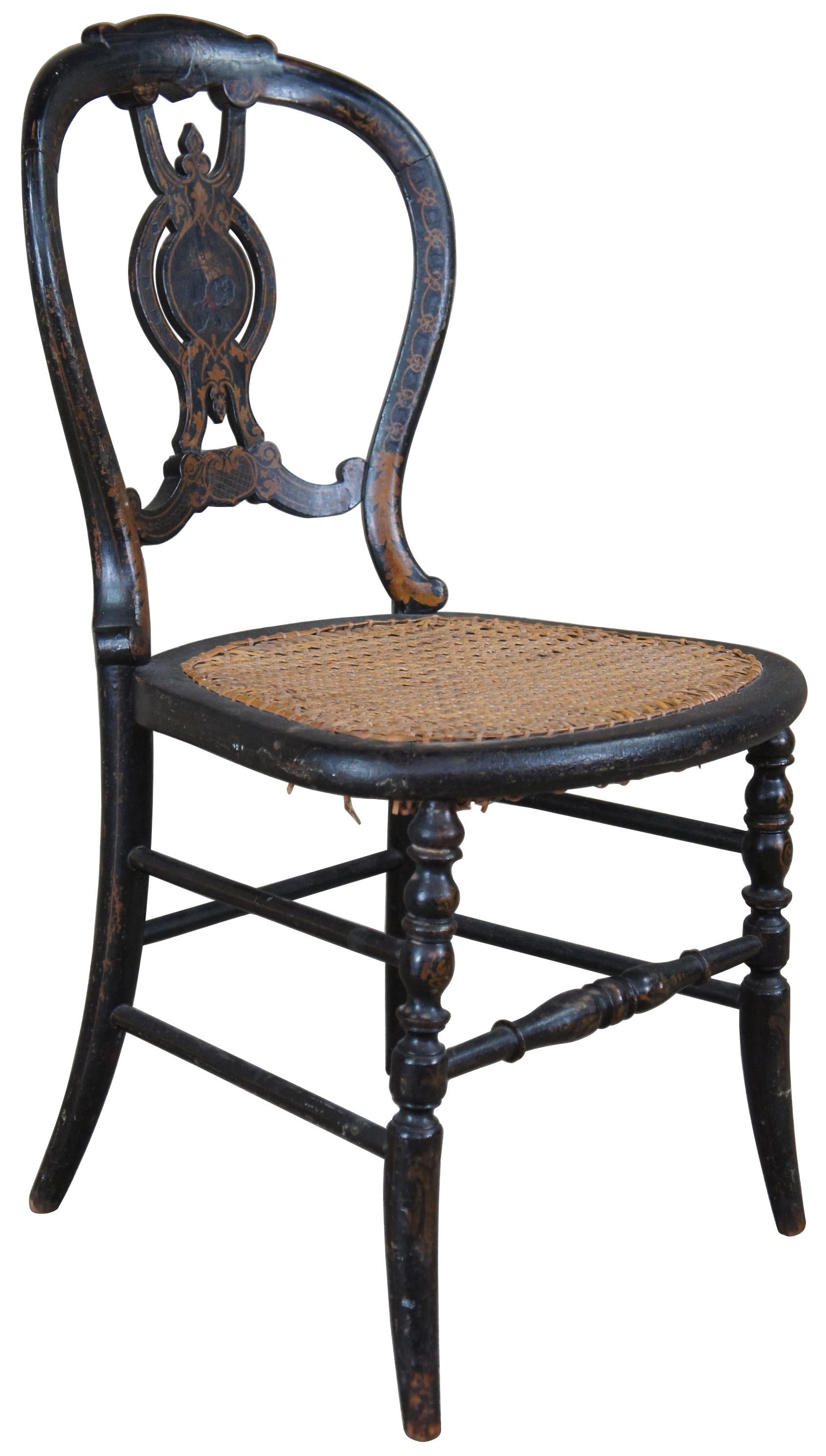 Antique Victorian parlor chair. Hand stencilled with an ornate pierced back with a caned seat and turned legs.
  