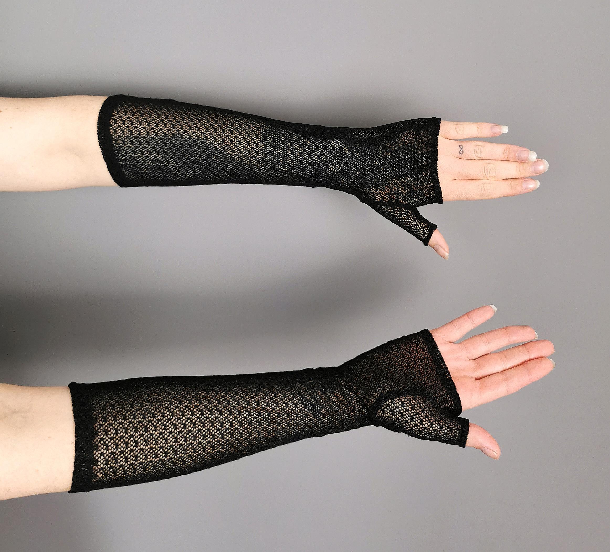 A rare pair of late Victorian fingerless gloves or mittens.

In a black nettting or fishnet type silk blend fabric.

This style has been copied for centuries and remains a very popular and wearable style today, working well with so many fashion