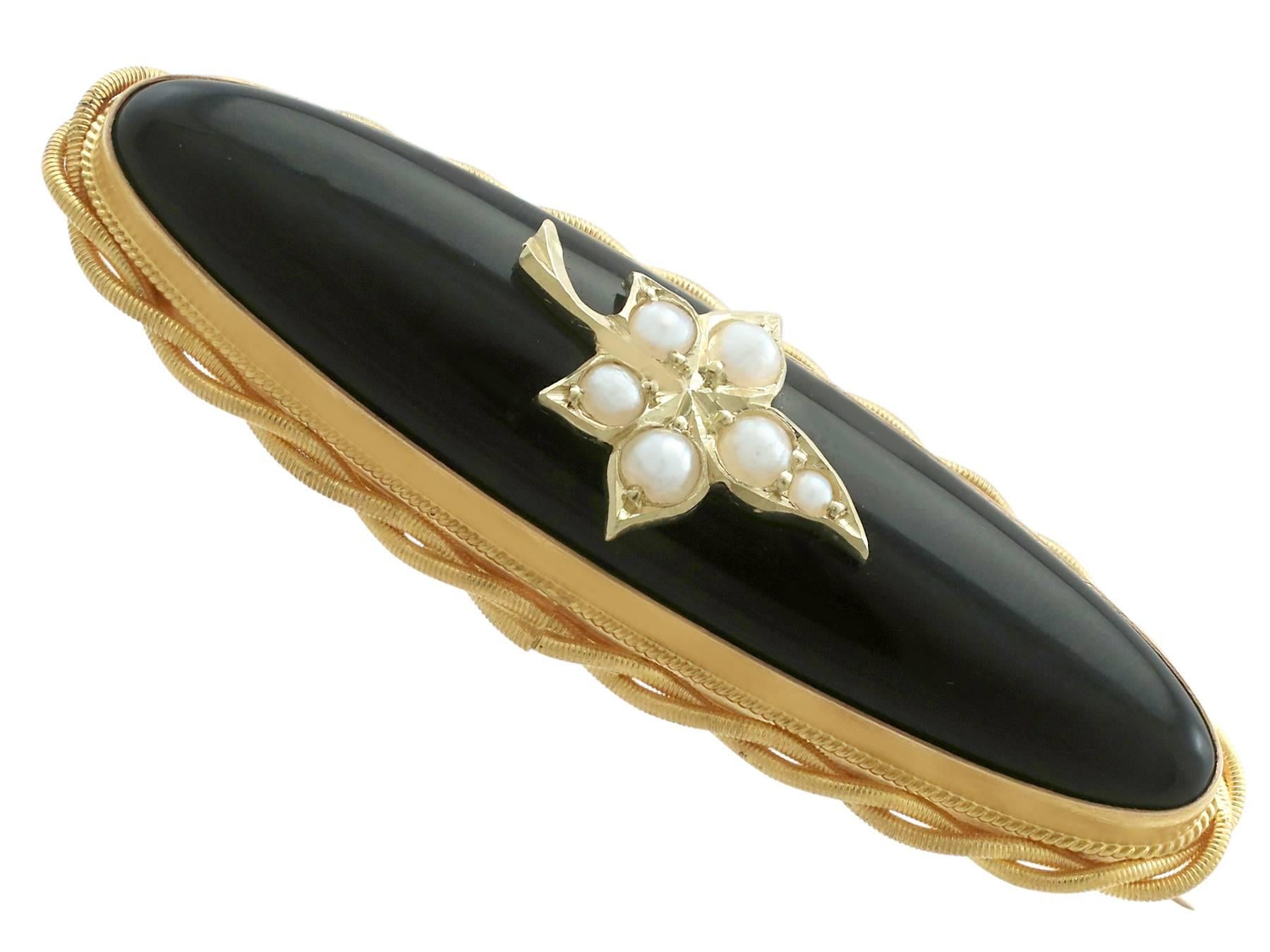 An impressive antique Victorian black onyx and seed pearl, 21 karat yellow gold mourning brooch with 14 karat yellow gold pin.

This fine and impressive Victorian mourning brooch has been crafted in 21k yellow gold with a 14k yellow gold pin.

The