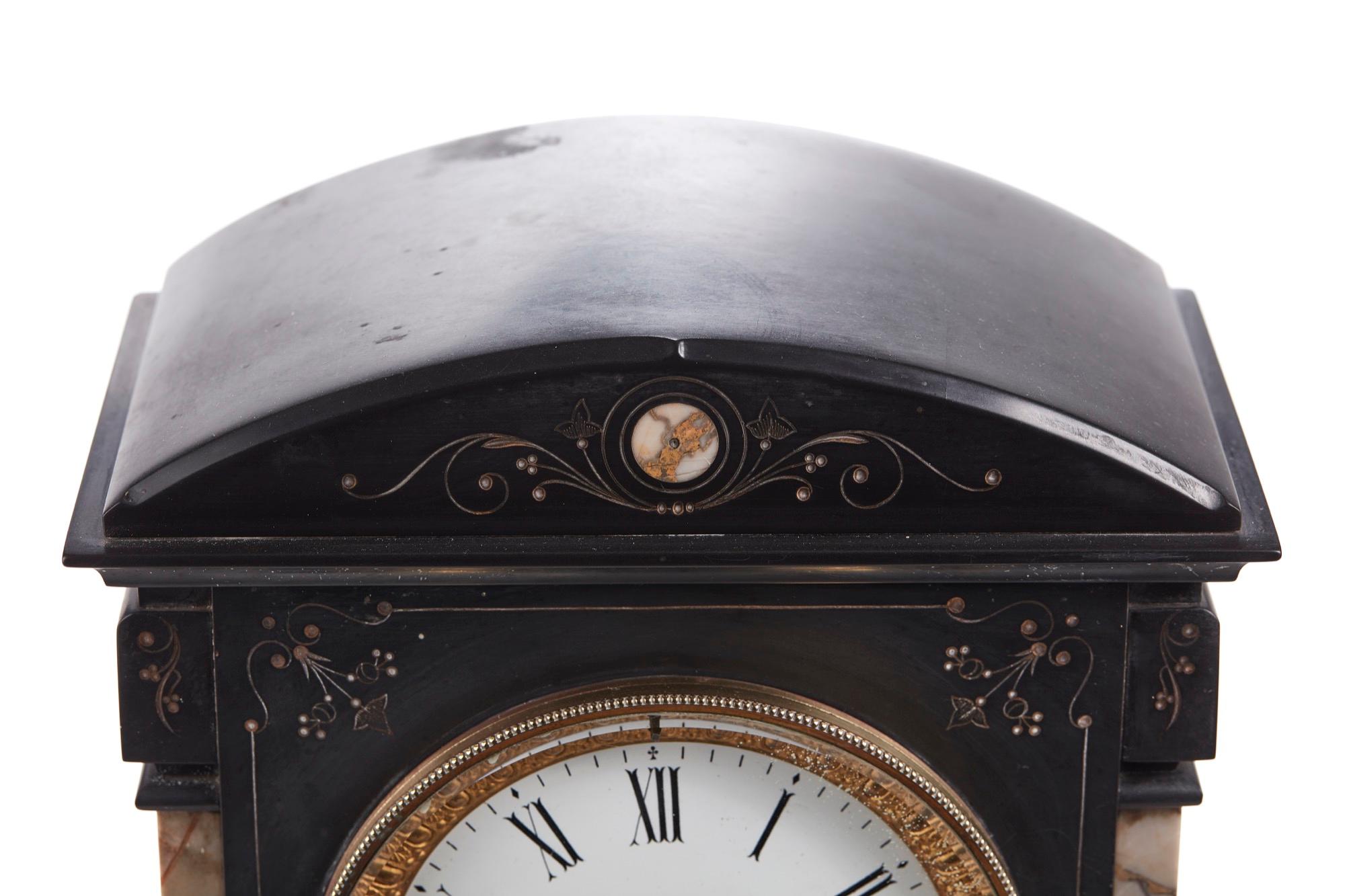 Antique Victorian black slate mantle clock with incised decoration and variegated marble pilasters, circular enamel dial with twin train movement. Perfect working order and with original key.