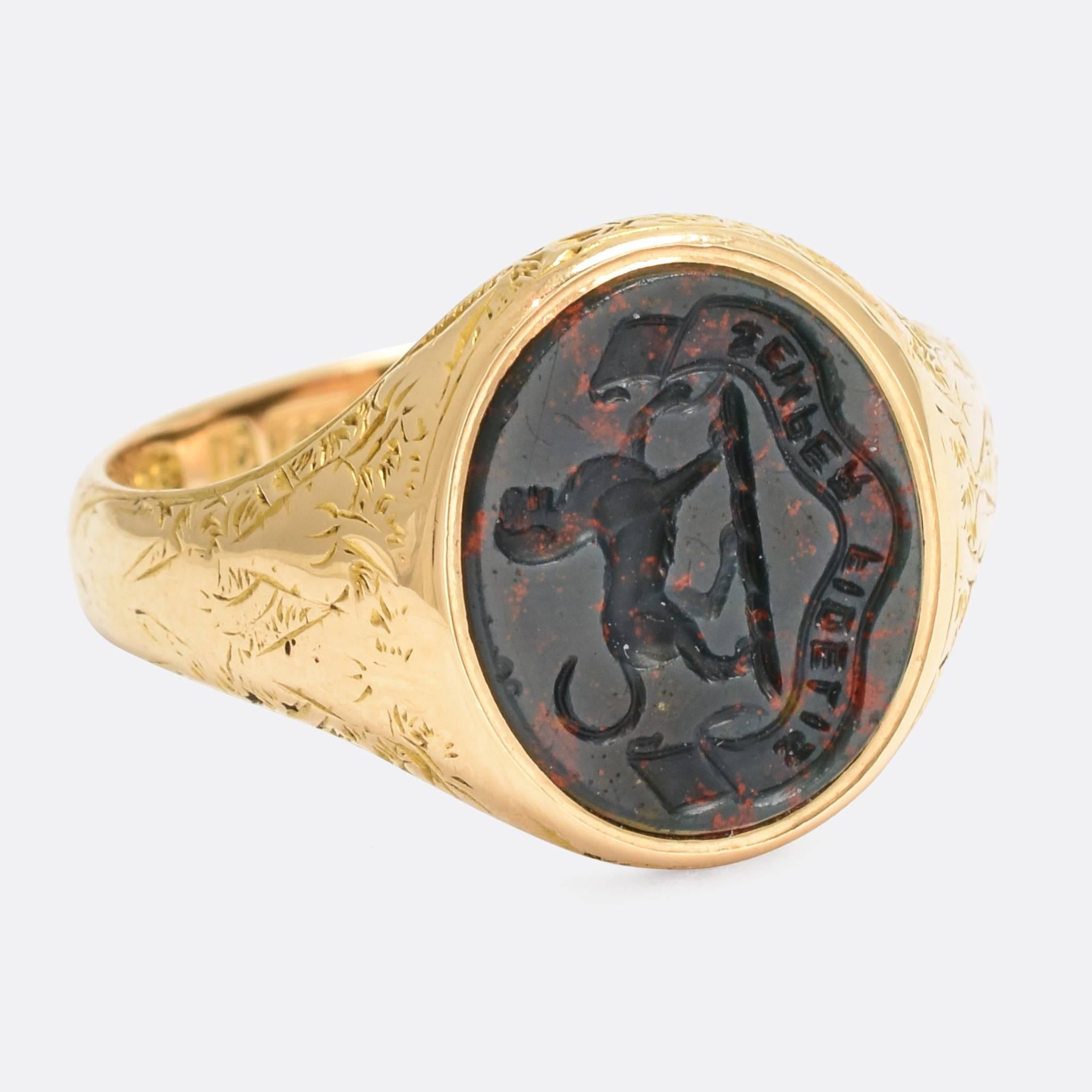 A superb antique Signet Ring, set with an oval bloodstone panel carved with an English heraldic crest. The crest depicts a Talbot, a now extinct breed of hunting dog said to be an ancestor of the Beagle, above the Latin motto: 