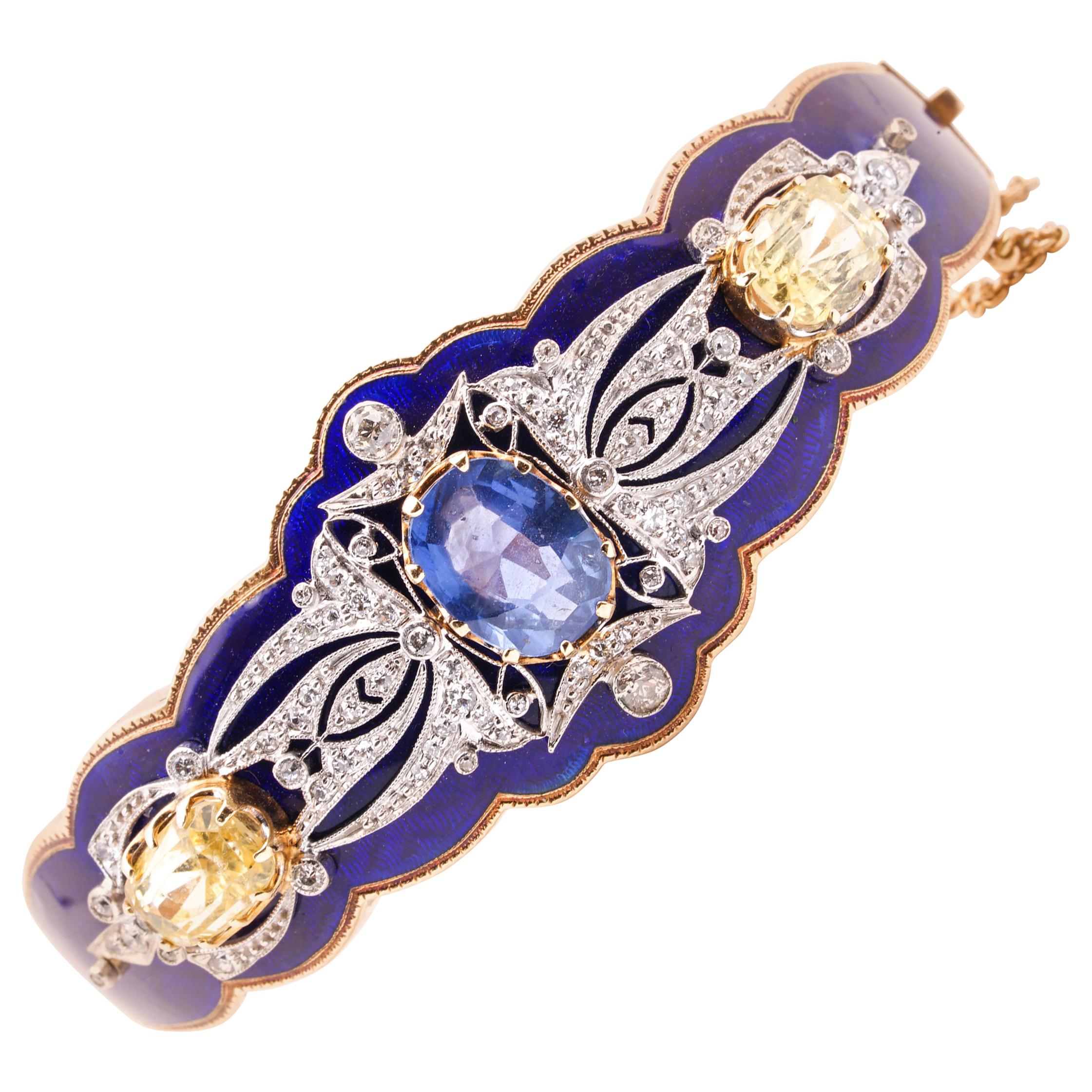 Antique Victorian bangle bracelet finely crafted in 14 Karat Gold featuring an exquisite Royal blue enamel finish and a mix of blue and yellow sapphires. One center oval blue sapphire weighs 3.48 cts and is certified by AGL ( American Gemological