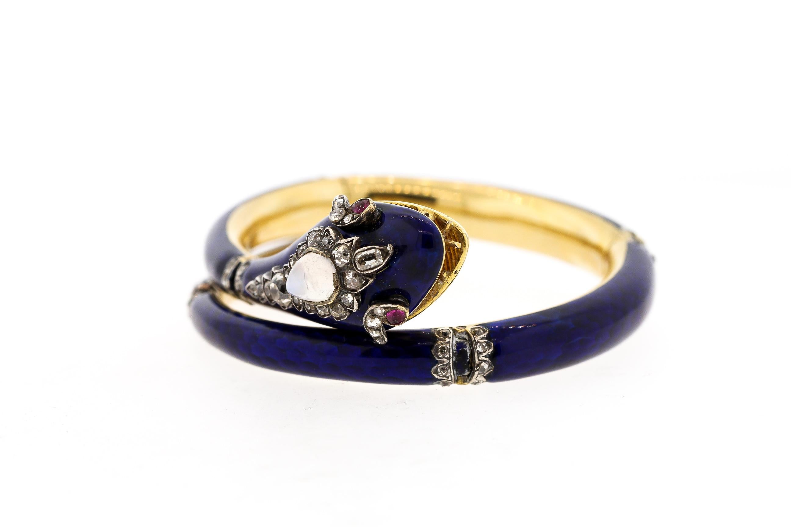 Lovely antique Victorian dark blue enamel articulated snake bracelet that wraps around the wrist, circa 1880. It is made in 18k gold with silver accents, and has a small place for memento underneath the head. The snake is set with rose cut diamonds