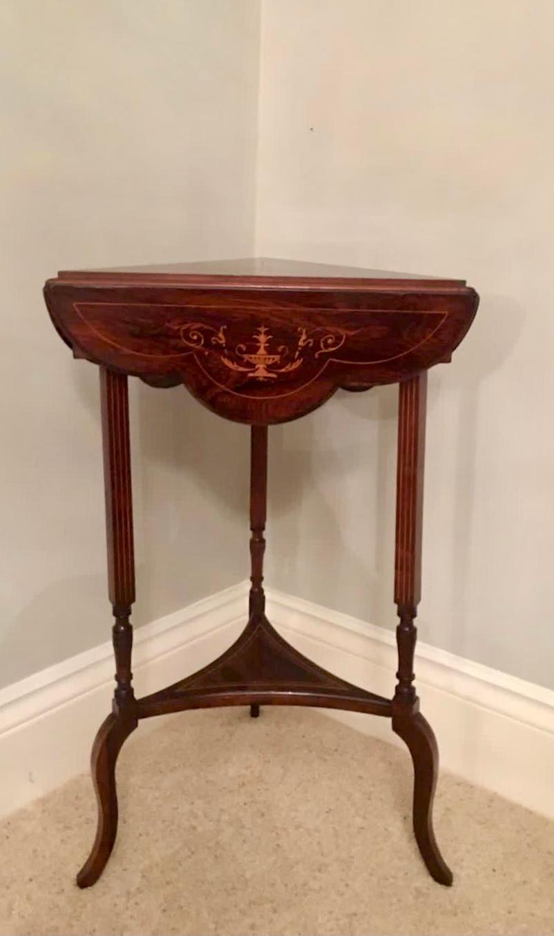 Antique Edwardian inlaid drop-leaf table having an unusual triangular shape, the top having a fine centre inlay with satinwood decoration, the three drop leafs having the same delightful inlay depicting urns, foliage and scrolls and a delightful