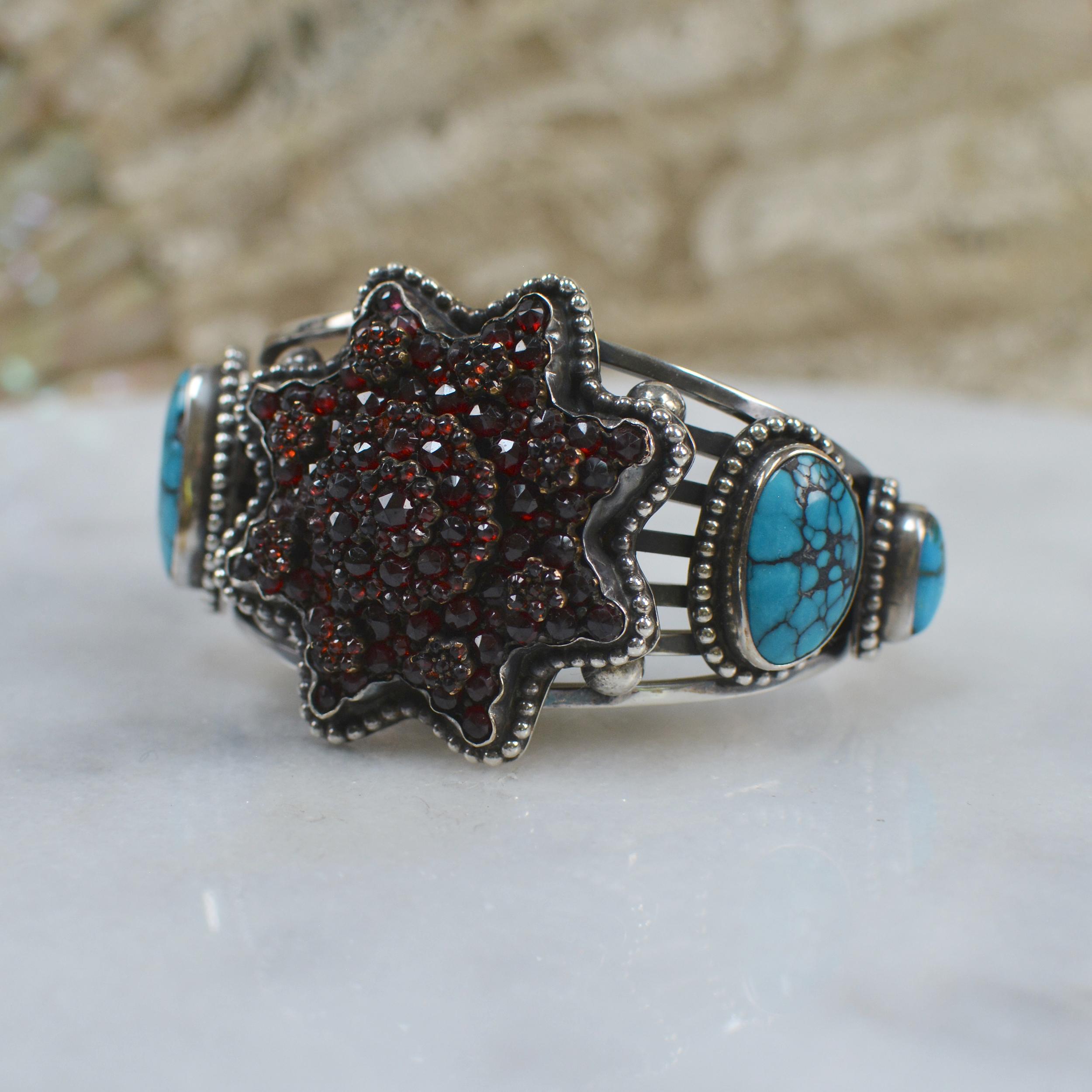 This important Jill Garber cuff bracelet has been designed and created to feature a wonderful nineteenth century antique Victorian Bohemian garnet star. All rose cut natural garnets are mounted in original old gold vermeil prong mountings. This