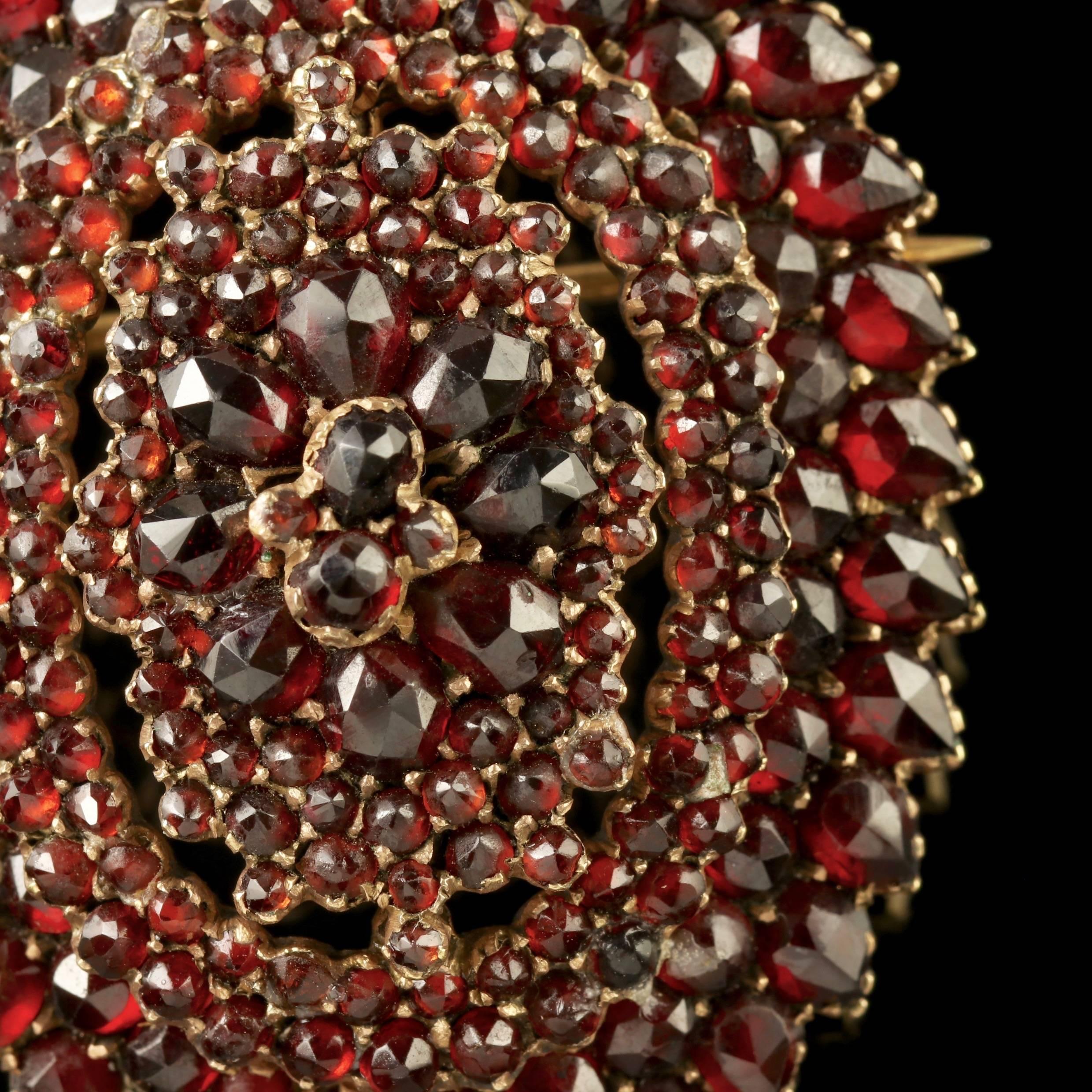 To read more please click continue reading below-

This beautiful antique Victorian Bohemian Garnet Gold locket brooch is Circa 1880. 

The fabulous locket is adorned with clusters of deep red Bohemian Garnet’s set in a beautifully designed