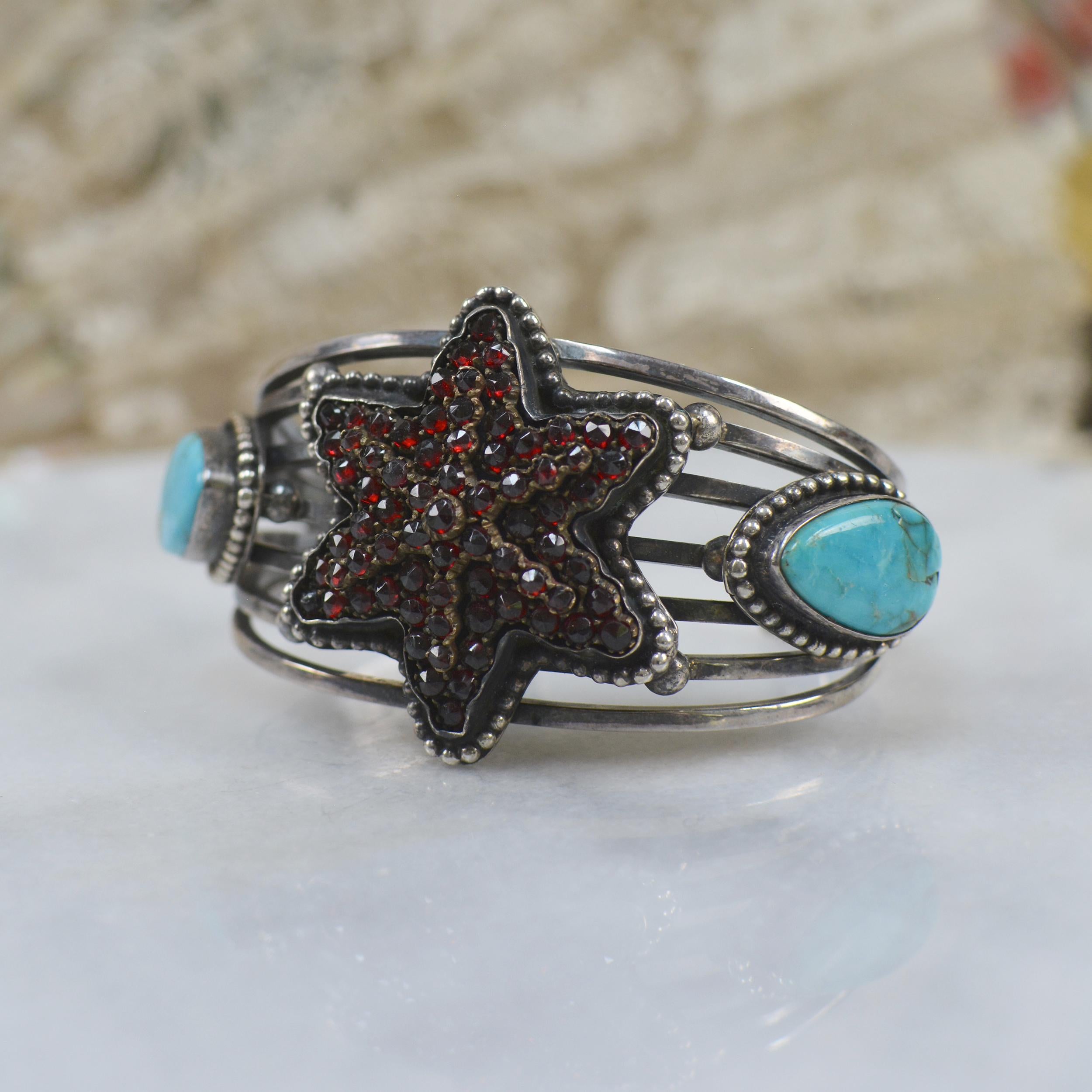 This divine Jill Garber cuff bracelet has been designed and created to feature an exquisite nineteenth century antique Victorian Bohemian garnet star. All rose cut natural garnets are mounted in original old gold vermeil prong mountings. East meets