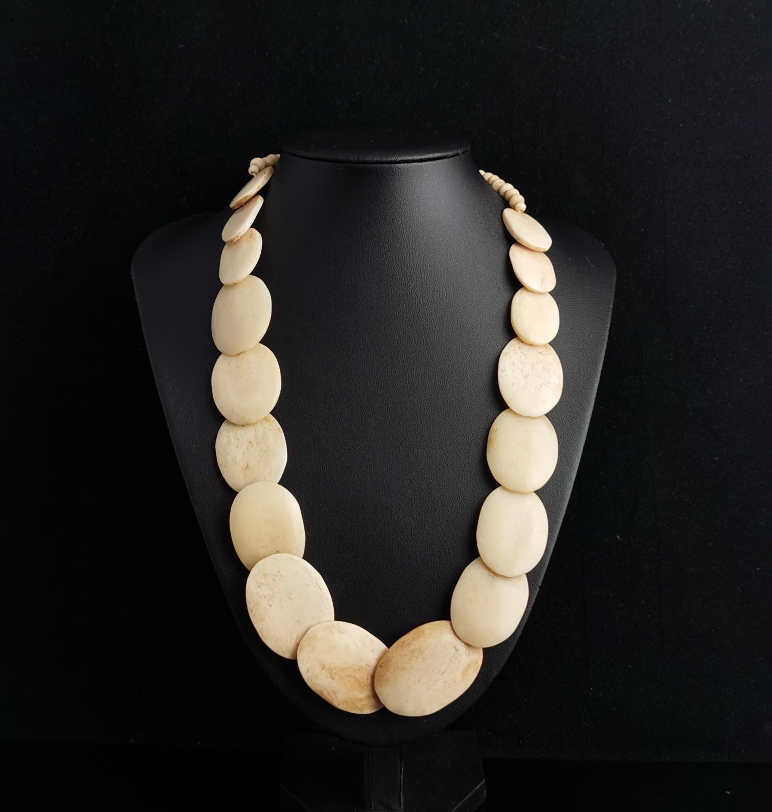 An interesting chunky antique Victorian bovine bone necklace.

It has large smoothed flat oval bone links or carved beads, these overlap each other slightly to make a collar type necklace.

The ends of the necklace has round carved bone beads and