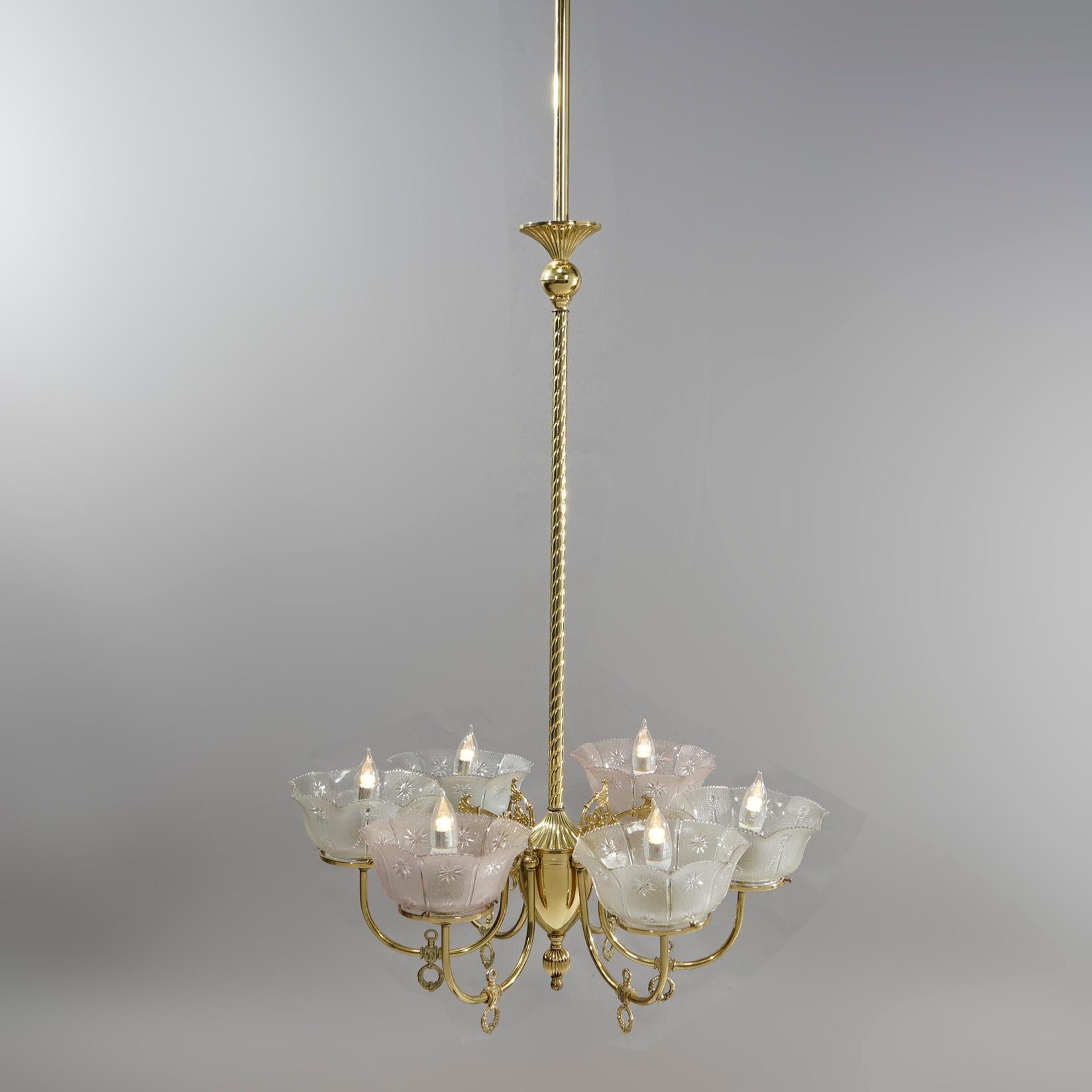 An antique Victorian electrified gas chandelier offers brass frame with rope twist shaft having six scroll form arms terminating in etched glass shades (non-matching), c1890

Measures- 79''H x 26.5''W x 26.5''D

Catalogue Note: Ask about DISCOUNTED