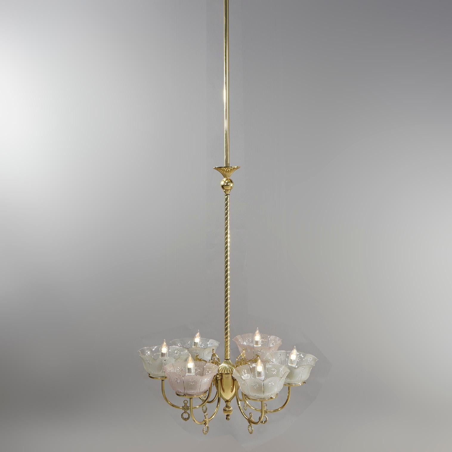 An antique Victorian electrified gas chandelier offers brass frame with rope twist shaft having six scroll form arms terminating in etched glass shades (non-matching), c1890

Measures- 78.25''H x 26''W x 26''D.

Catalogue Note: Ask about DISCOUNTED