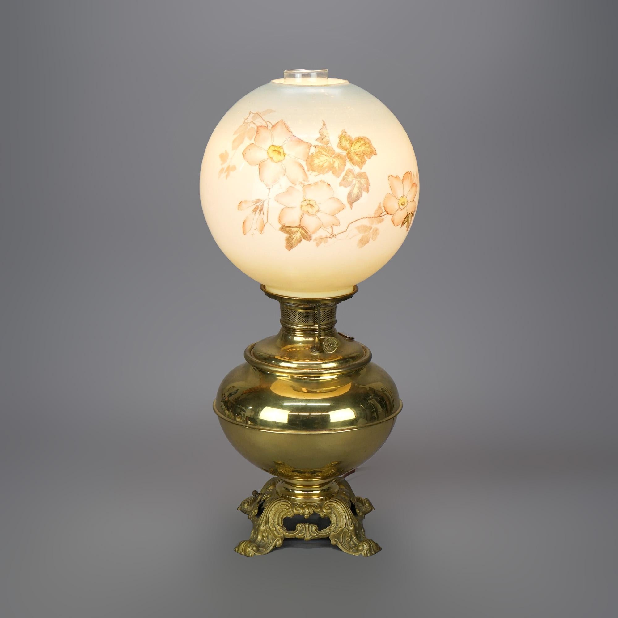 An antique Victorian gone with the wind table lamp offers painted glass globe with floral design over brass font raised on base with scroll form feet, electrified, circa 1890

Measures- 22.25''H x 9.5''W x 9.5''D.