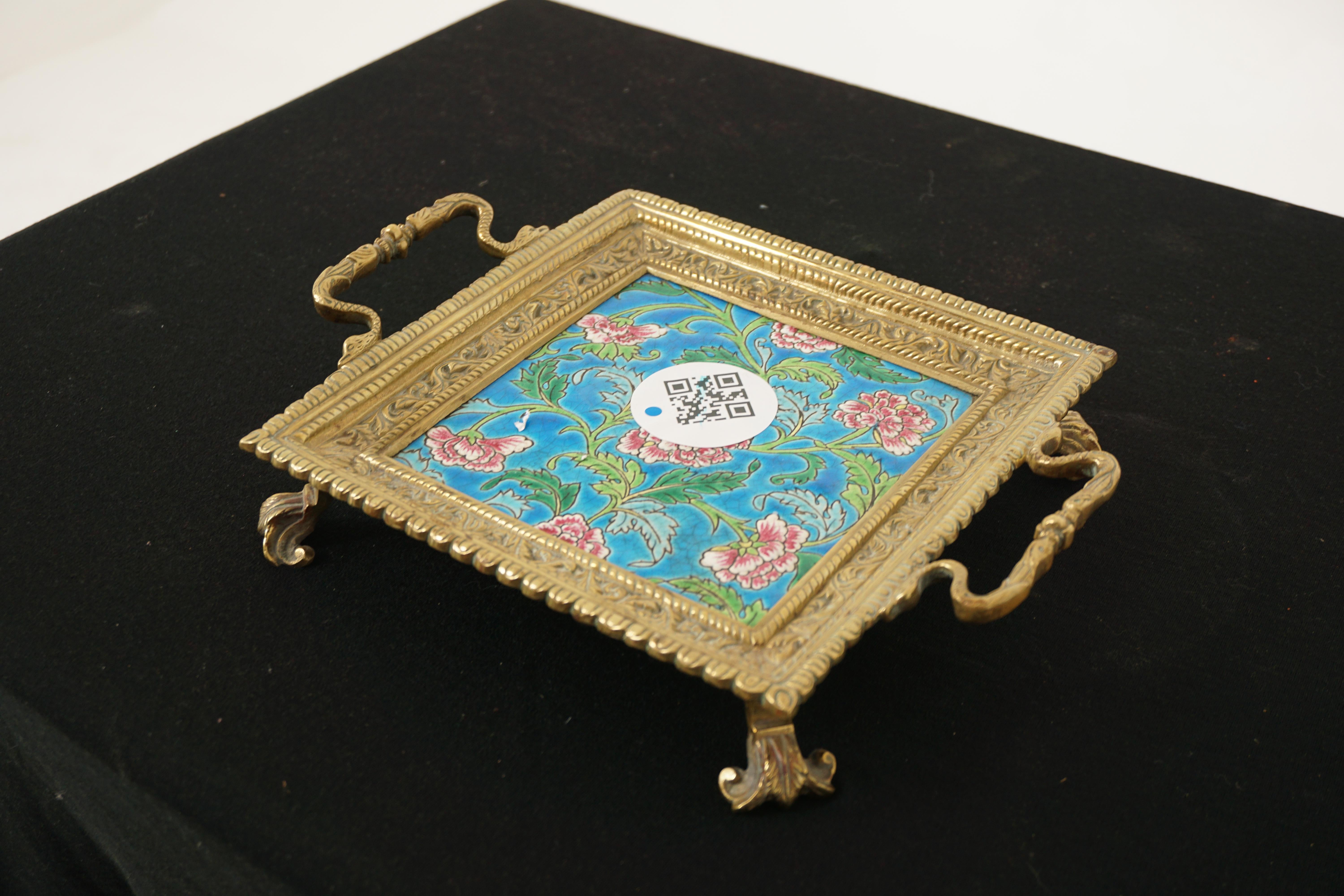 Antique Victorian brass trivet, stand, tray Majolica Plate, England 1890, H57

Solid brass
Majolica tile
Square brass shape with Majolica tile
Ornate decoration with snake shaped handles
Has Regency style feet on the base
All solid with no