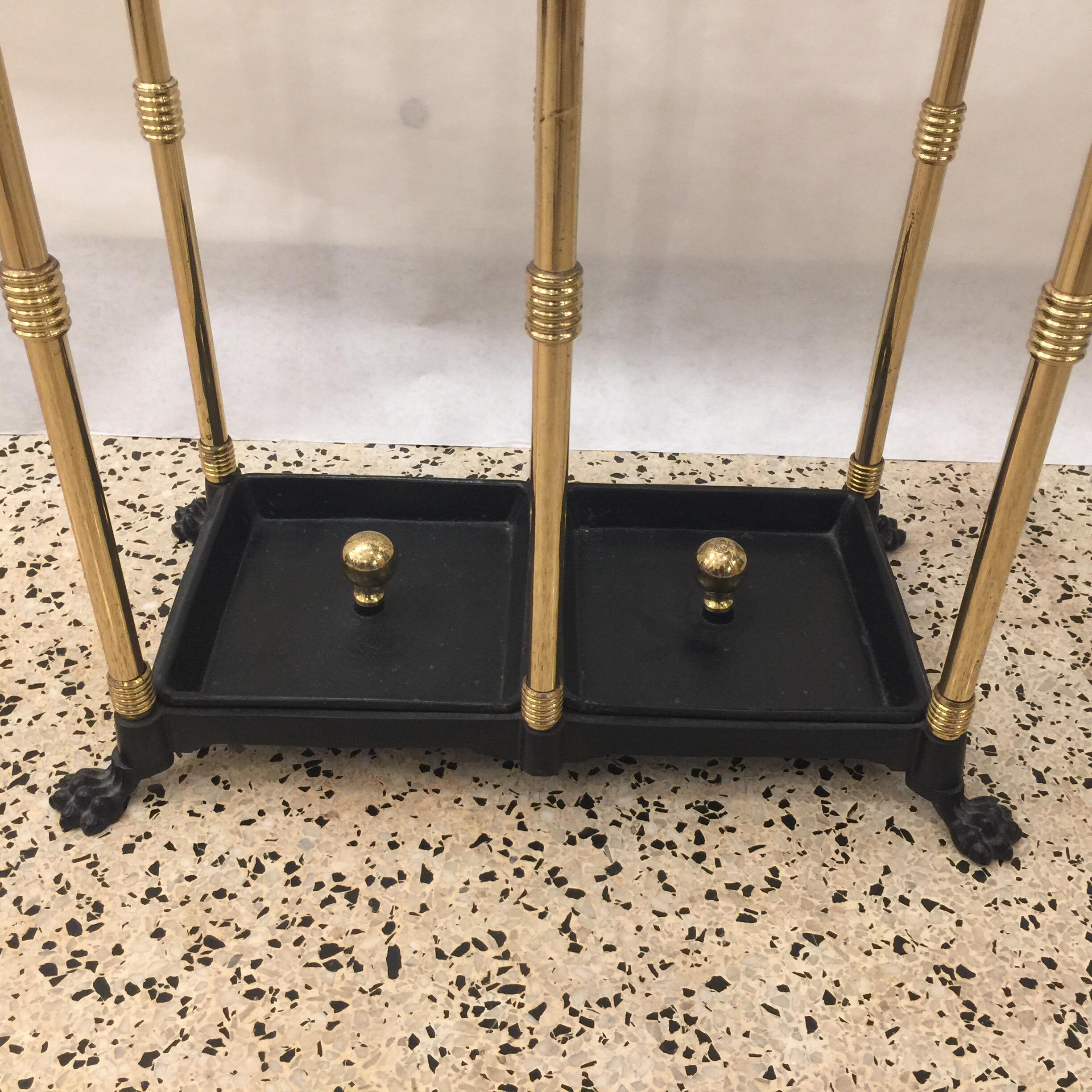 This is a wonderful solid brass and iron umbrella holder with removable trays to bottom (two). The Claw feet and brass ball finials are so fun and whimsical.