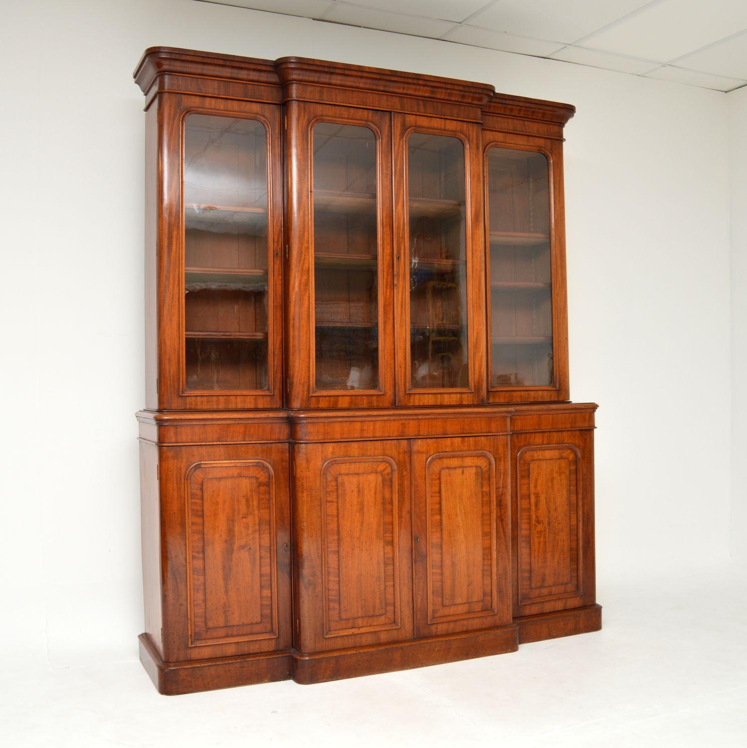 A grand and impressive antique Victorian breakfront library bookcase. This was made in England, it dates from the 1860-1880 period.

It is very rare to find this model from the period, it is a great size and is of super quality. The wood has a