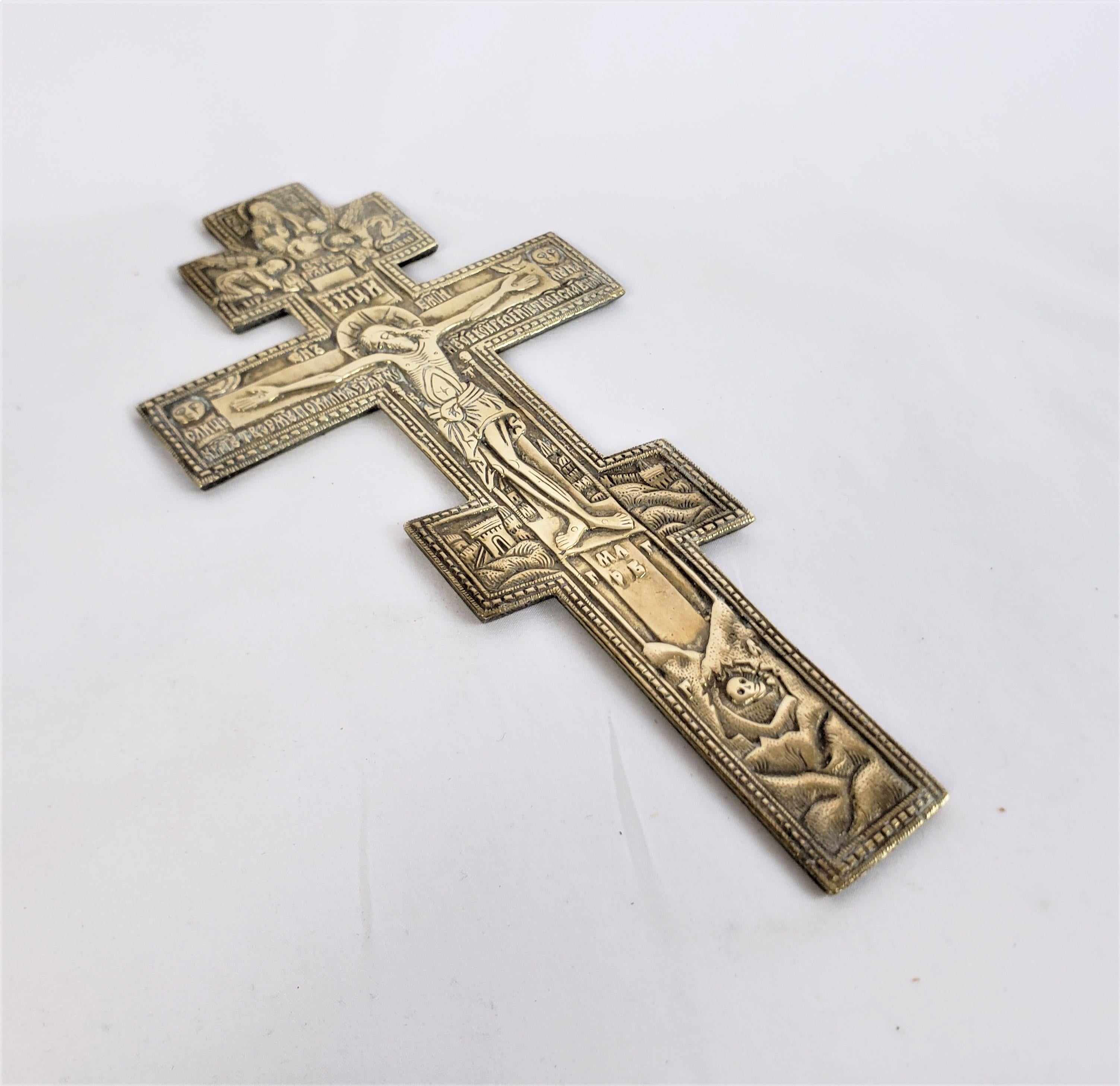 This antique crucifix is unsigned, and dates to approximately 1880 and done in the classical Imperialist style. The crucifix is composed of cast and patinated bronze and depicts Jesus on the cross with angels at the top and various symbolism