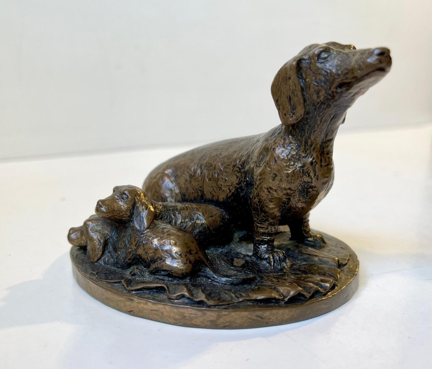 A fine a very detailed small desk sculpture depicting a dachshund mother with puppies. It is signed indistinguishable to its base but we have not been to find the maker. Measurements: 7.5 x 10.8 cm.