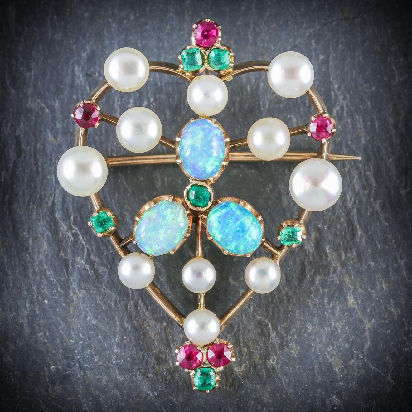 This colourful antique gemstone brooch is Victorian, Circa 1900

The wonderful piece is decorated with 0.45ct of Emerald, 5ct of Pearl, 1.8ct of Opal and 0.4ct of Ruby

All set in 18ct Yellow Gold and fitted with a sturdy pin and catch

Complete
