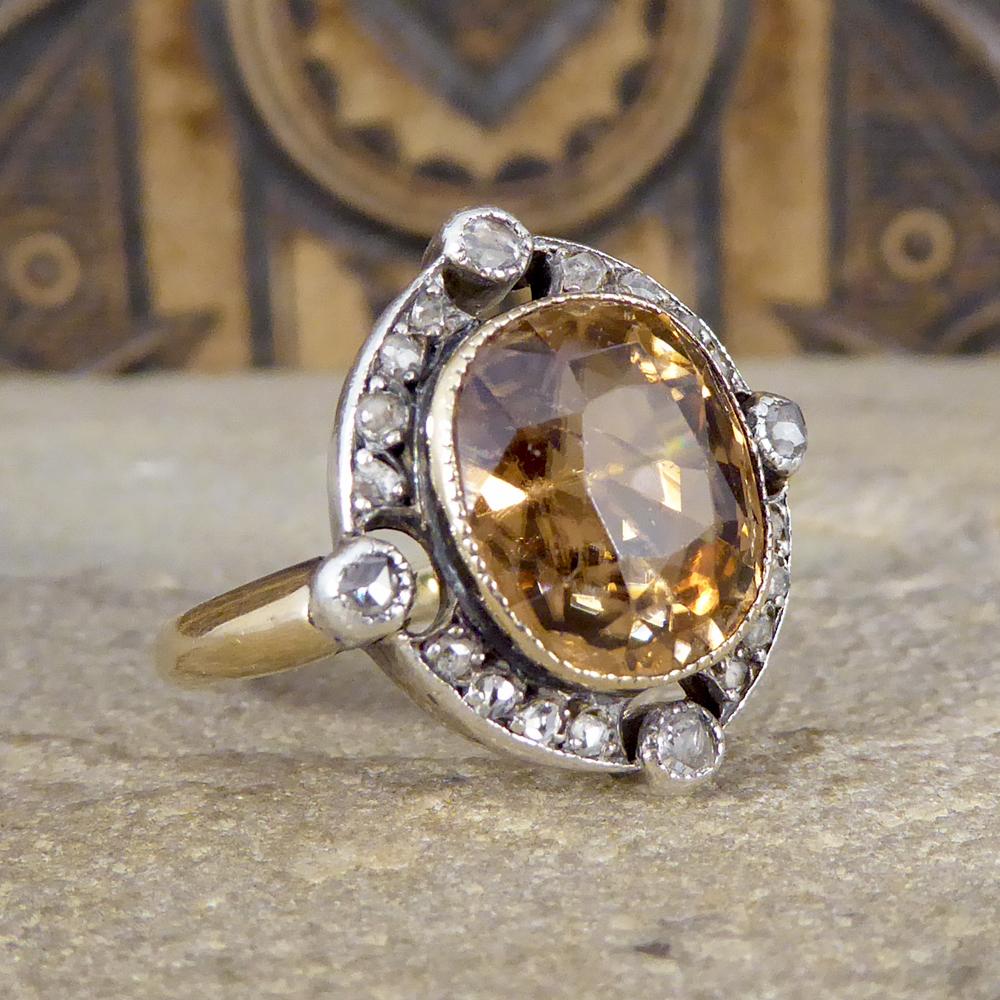 This beautiful ring has been crafted in the Late Victorian era with a gorgeous and elegant old look to it. It features a large Brown Zircon gemstone in a rub over collar setting with a milgrain edge. The character of this ring is brought through its