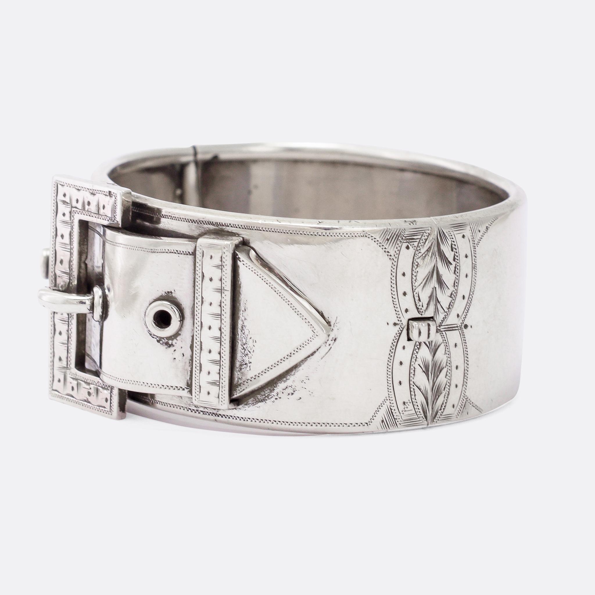 A gorgeous, chunky cuff bangle with a large buckle and strap motif. It dates from the Victorian period - circa 1880 - crafted in Sterling silver throughout. The buckle motif was popular in Victorian jewellery, with Queen Victoria herself said to