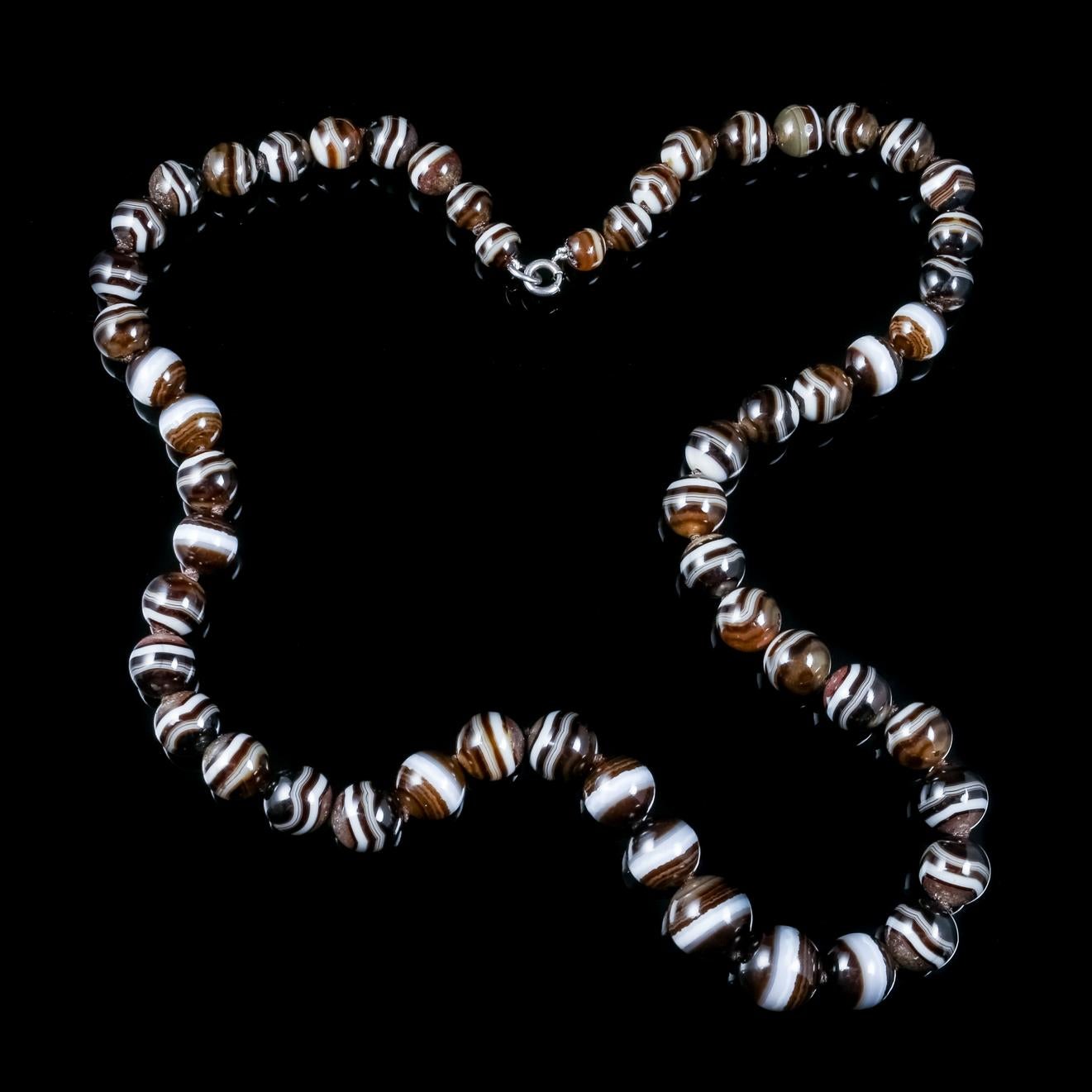 An exquisite antique Victorian necklace made up of lovely Bullseye Agate beads Which graduate in size from the clasp down. 

The Agates are a wonderful dark black/ brown colour and known as Bullseye Agates for their multiple white bands which are