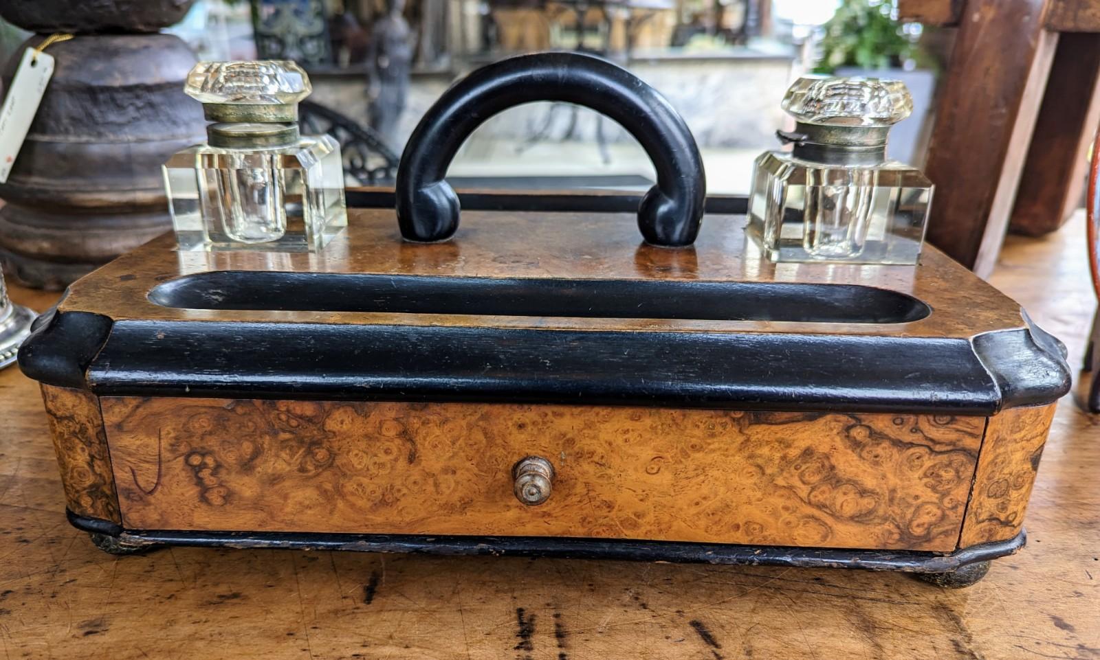 Stunning antique Victorian desk set with the original pair of glass inkwells, sitting on a lovey quality figured burled wood writing box with a molded edge. Features two cut crystal inkwells and a drawer along with a handle for carrying.