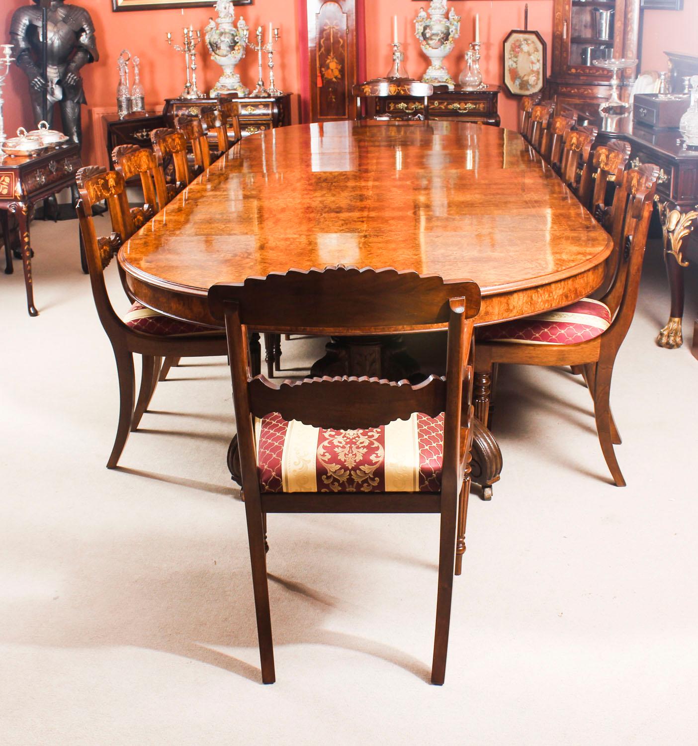 This is a magnificent dining set comprising an antique Victorian split base burr walnut and marquetry dining table, circa 1880 in date and a matching set of 14 bespoke dining chairs.

The table has been hand-crafted from burr walnut, and the