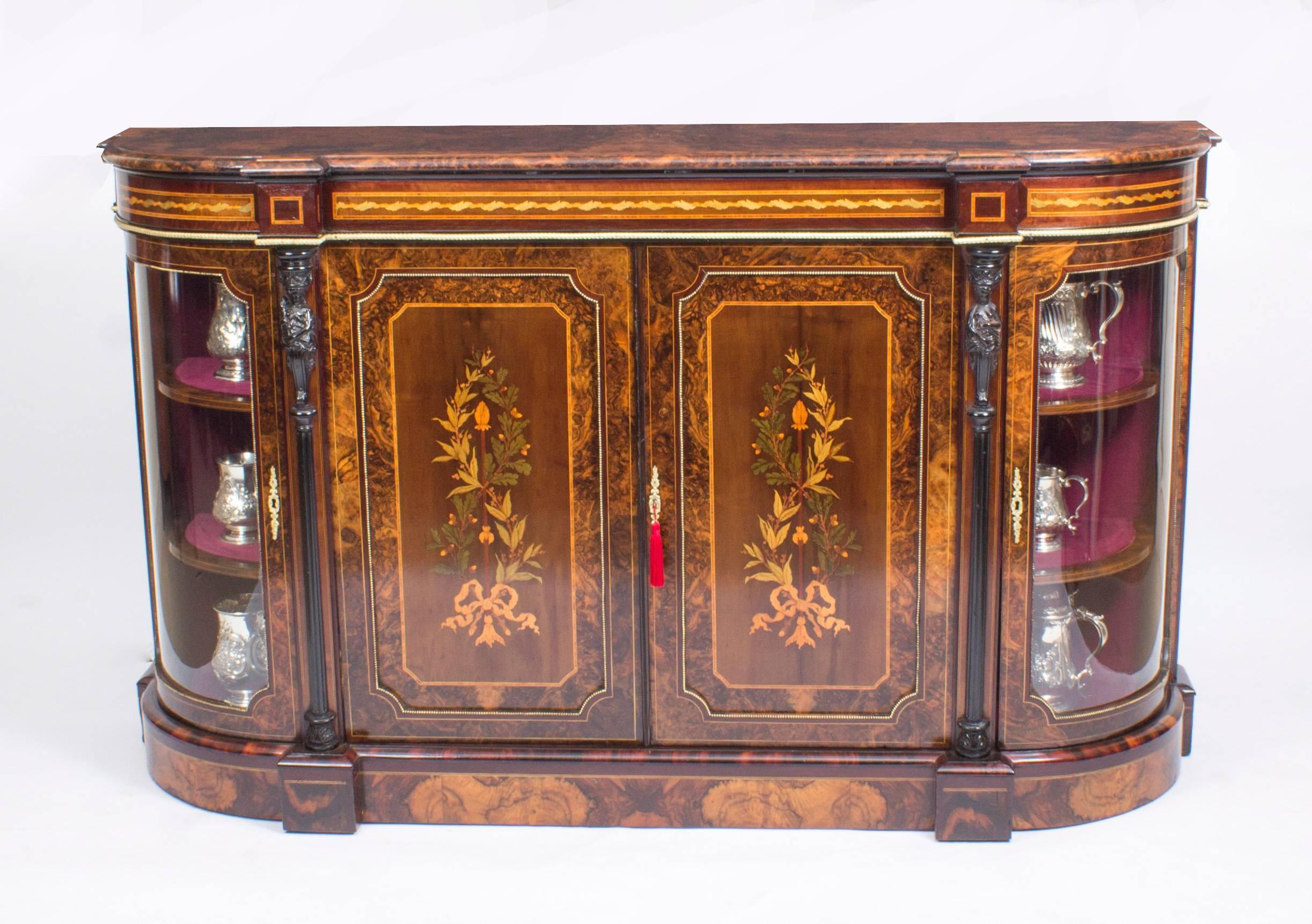 This is a stunning antique Victorian burr walnut and marquetry inlaid credenza, circa 1860 in date.

The entire piece highlights the unique and truly exceptional pattern of the book matched burr walnut veneers, and it has been enriched by the