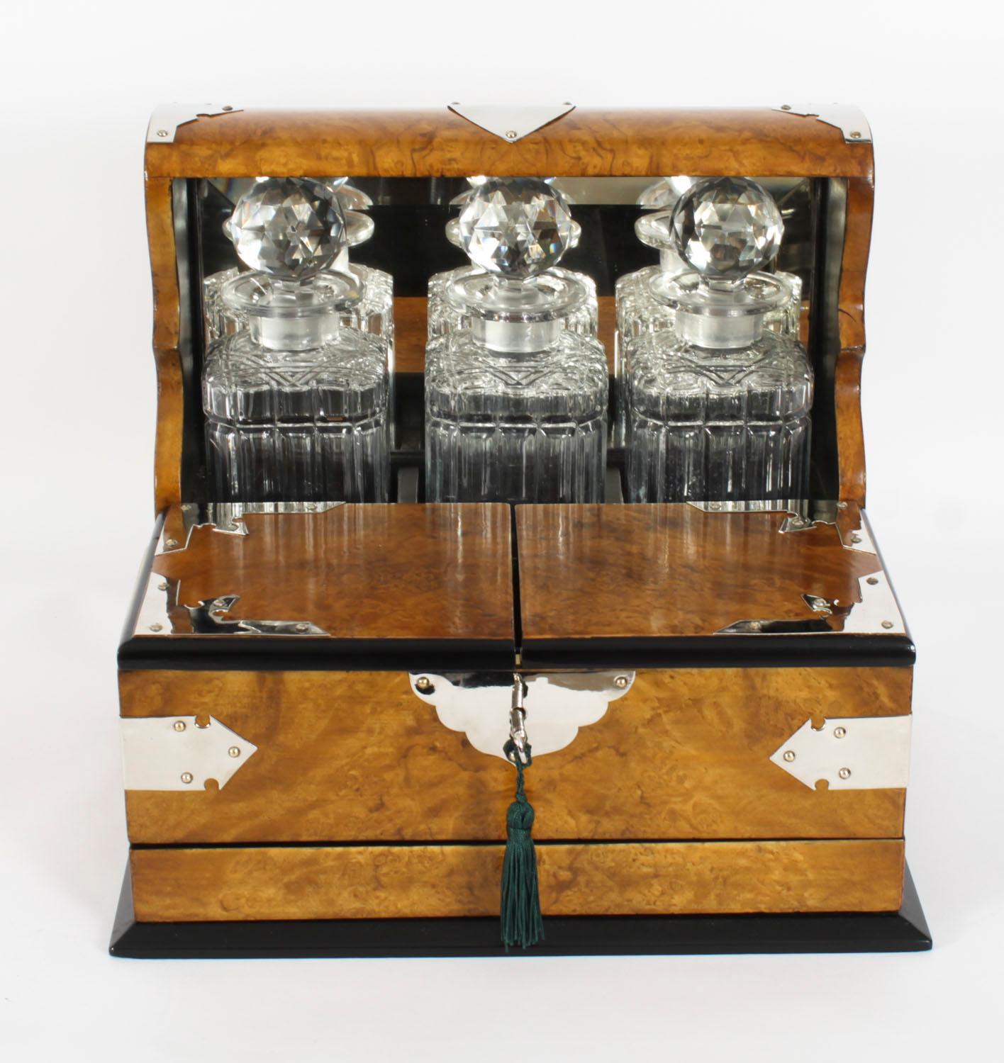 This is a superb antique Victorian burr walnut and ebonised cased three decanter tantalus with decorative silver plated cut brass gothic revival mounts and carry handles to the sides, circa 1880 in date.

This magnificent tantalus features three