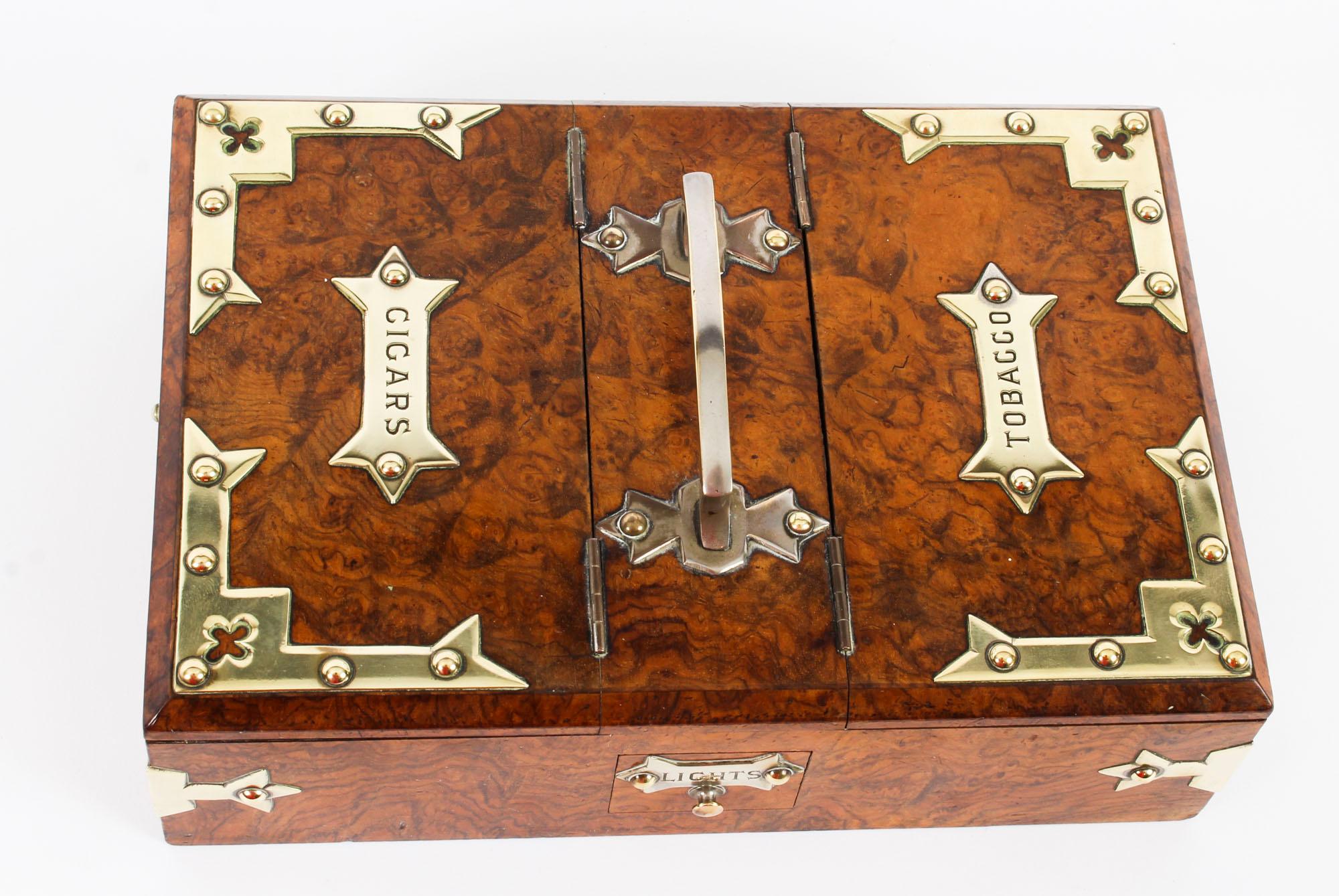 A lovely Victorian burr-walnut and brass-mounted cigar box with fitted interior, circa 1870 in date.

The rectangular box with Gothic style brass mounts and labels features a double hinged top for cigars and tobacco.

There is a small drawer to