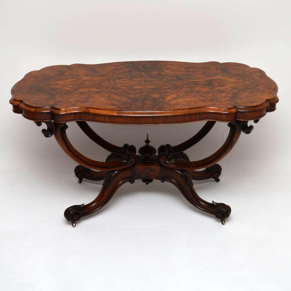 This antique Victorian centre table is a stunning piece of furniture and is 100% original. It has a shaped scalloped burr walnut top with amazing patterns within the veneers, which sits on top of a solid walnut basket shaped base. This table has a