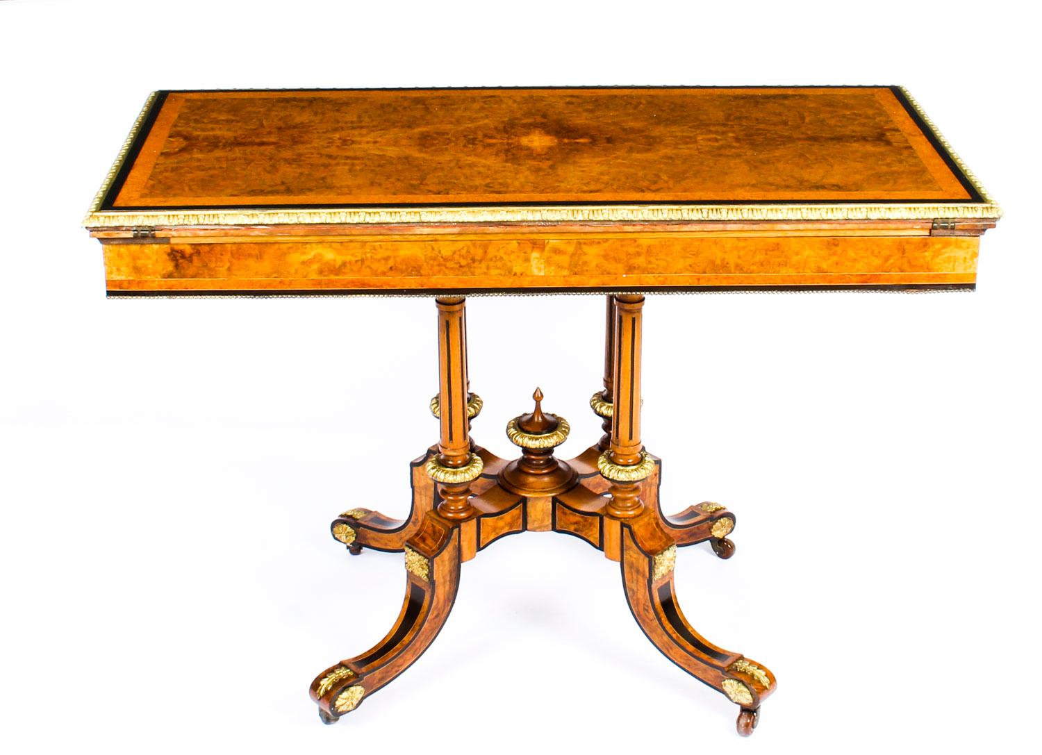 This is an attractive English antique Victorian burr walnut and ebonised card table, with impressed makers mark of the renowned cabinet makers Holland & Sons, circa 1860 in date.

This gorgeous card table is crafted from the most beautiful burr