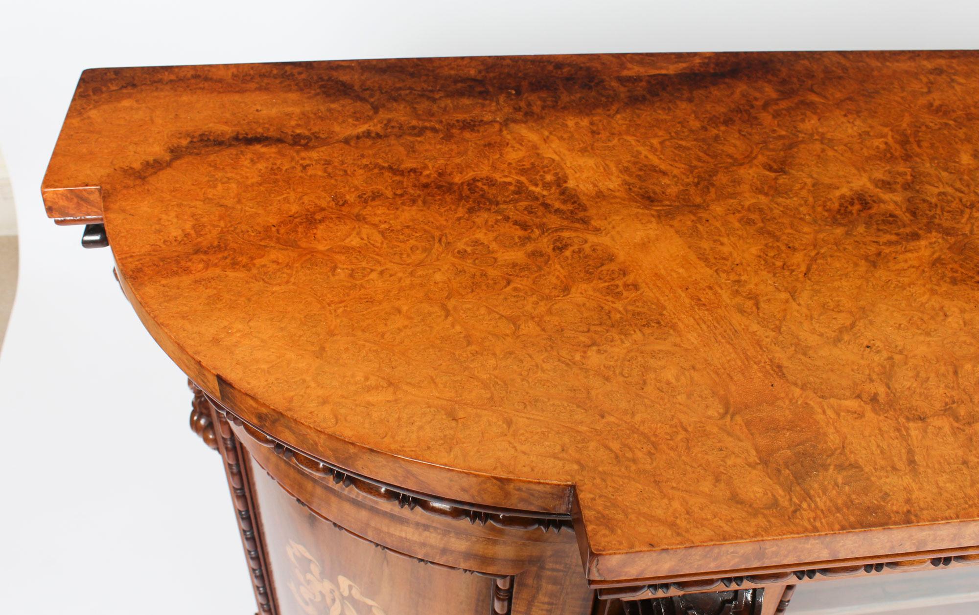 This is a superb antique early Victorian bow ended burr walnut, Gonçalo alves and marquetry inlaid credenza, circa 1850 in date.

The entire piece highlights the unique and truly exceptional pattern of the book matched burr walnut veneers on the