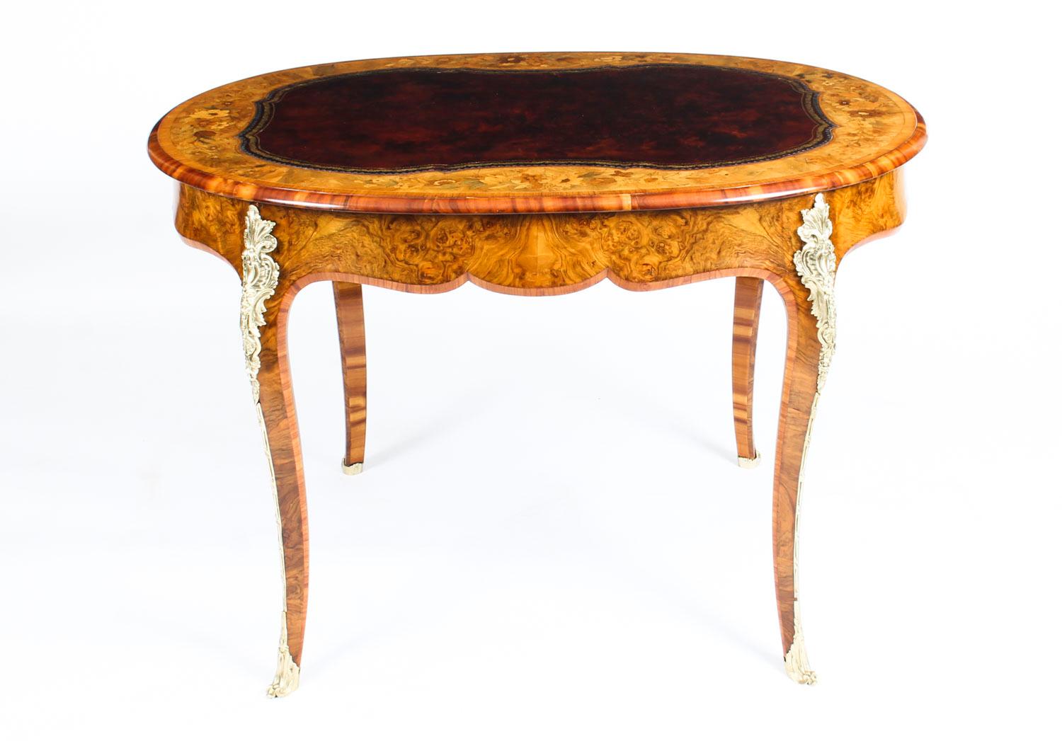 A stupendous antique Victorian burr walnut, floral marquetry and ormolu mounted writing table, circa 1860 in date.

This stunning desk is crafted from beautiful burr walnut with an inset gold tooled burgundy leather that has a wonderful band of
