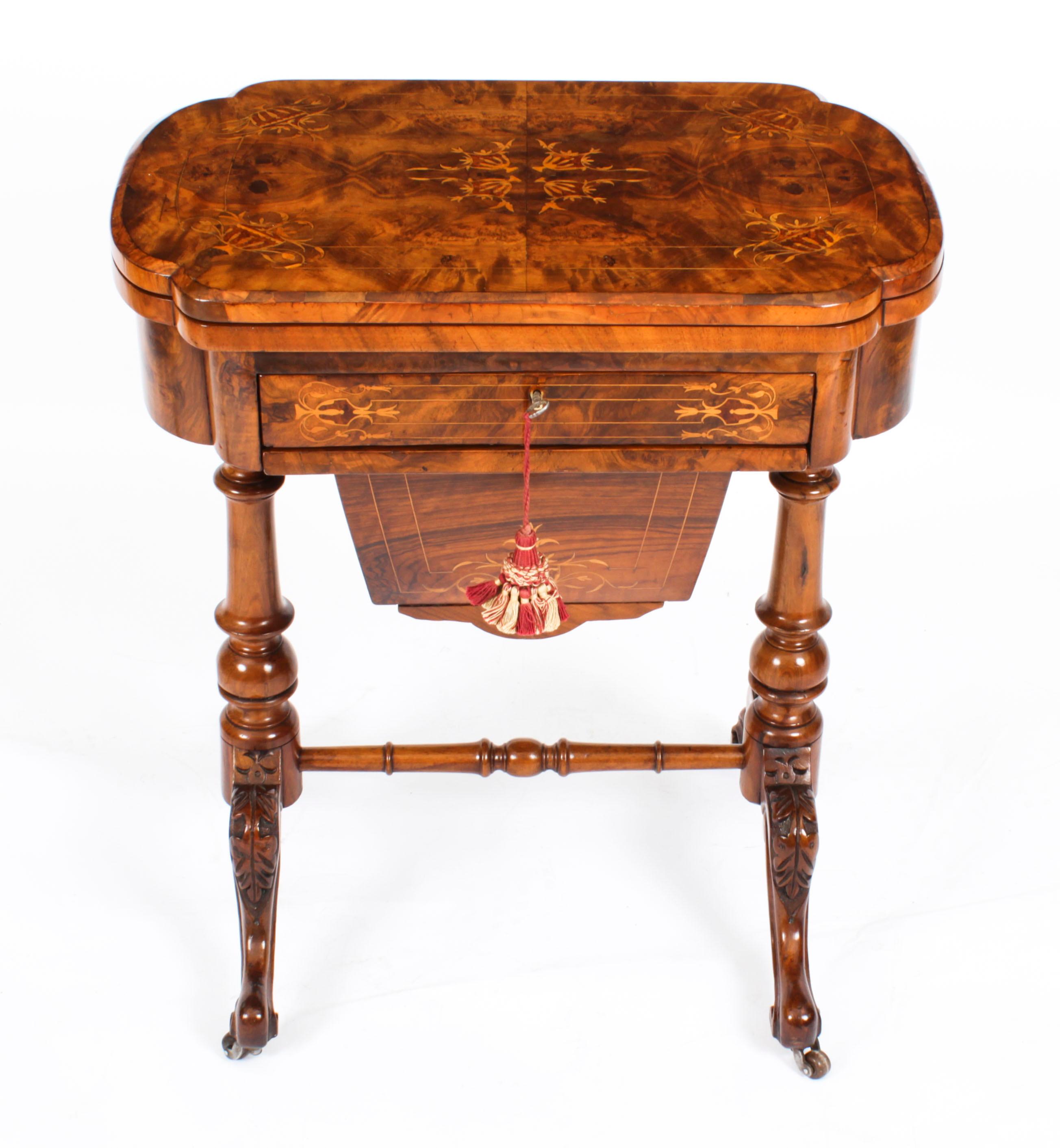 This is a fabulous antique Victorian burr walnut games and work table, circa 1870 in date.

It is made of beautiful burr walnut that has elegant satinwood line inlaid marquetry decoration. The hinged top opens to reveal a fabulous gaming interior