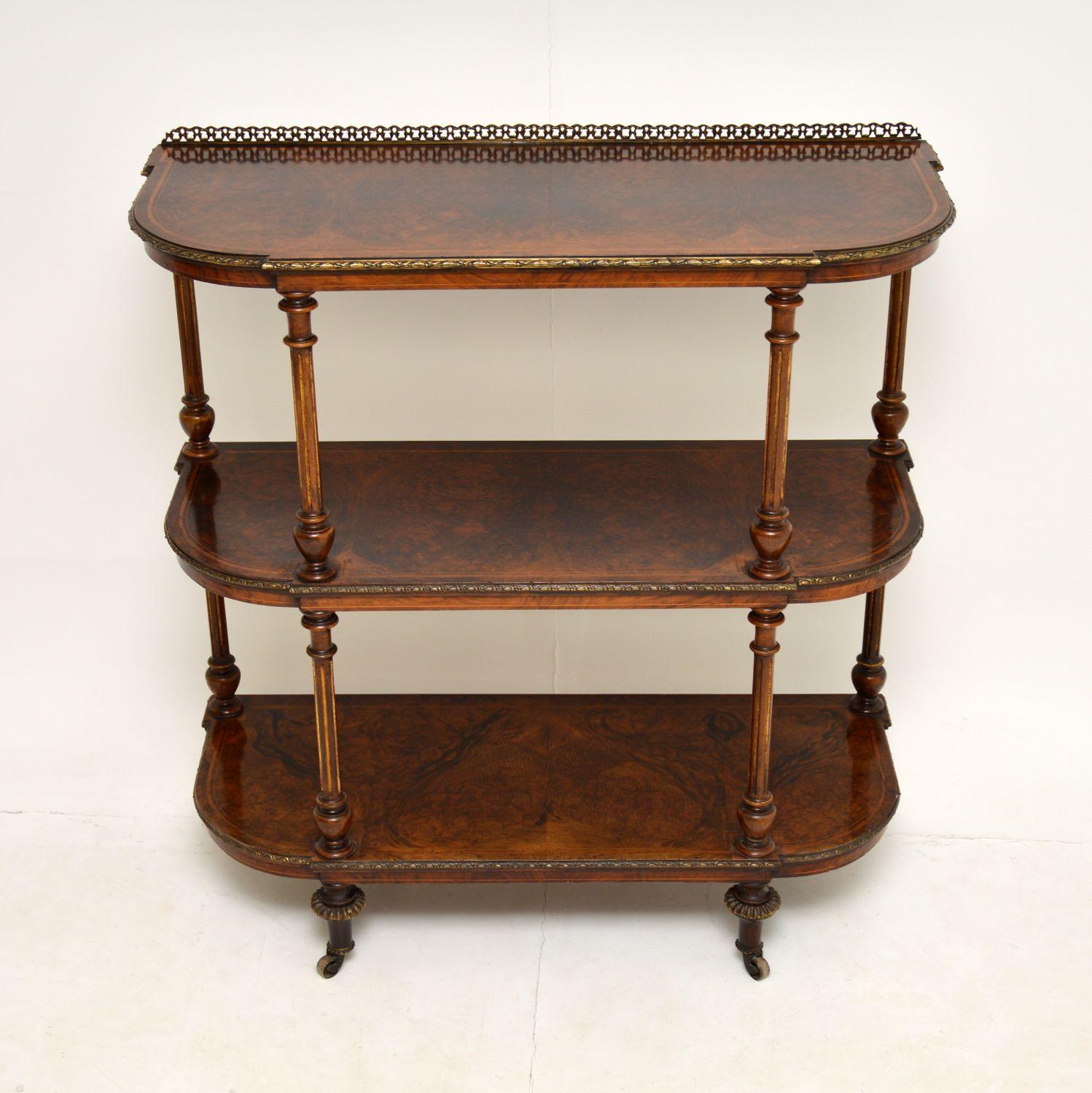 A stunning antique Victorian three tier étagère or buffet on casters. This was made in England, it dates from around the 1860-1880 period.

The quality is superb, this has wonderful burr walnut veneers on each tier, bordered with satin wood inlay.