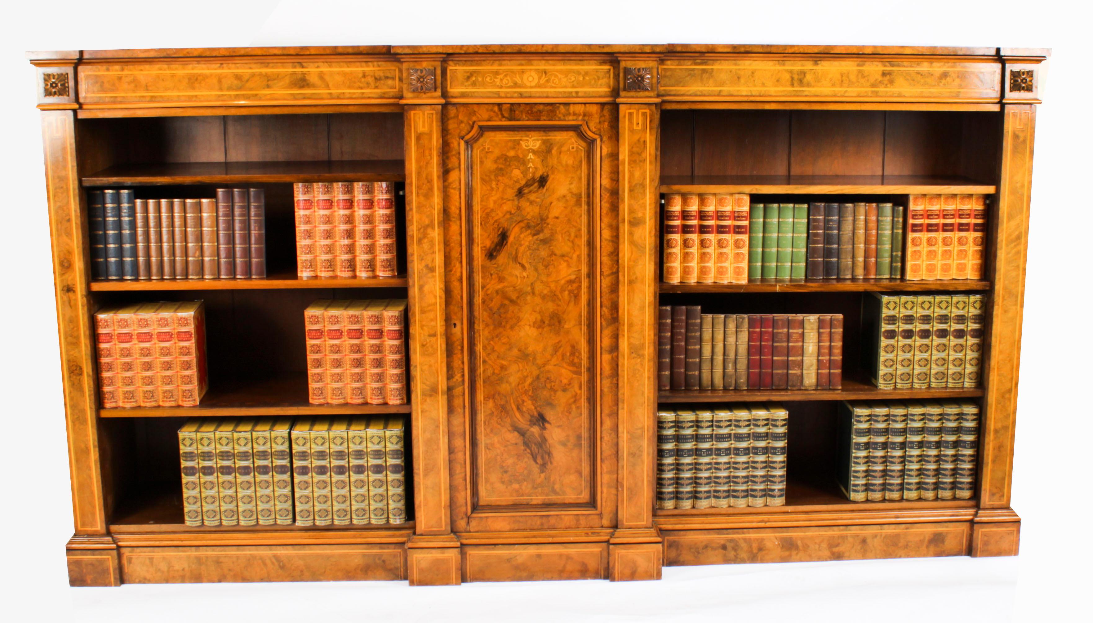 This is a superb antique Victorian burr walnut, marquetry inlaid breakfront open bookcase, circa 1860 in date.
 
The bookcase features beautiful satinwood crossbanding with four carved anthemion plaques, the breakfront central moulded cupboard