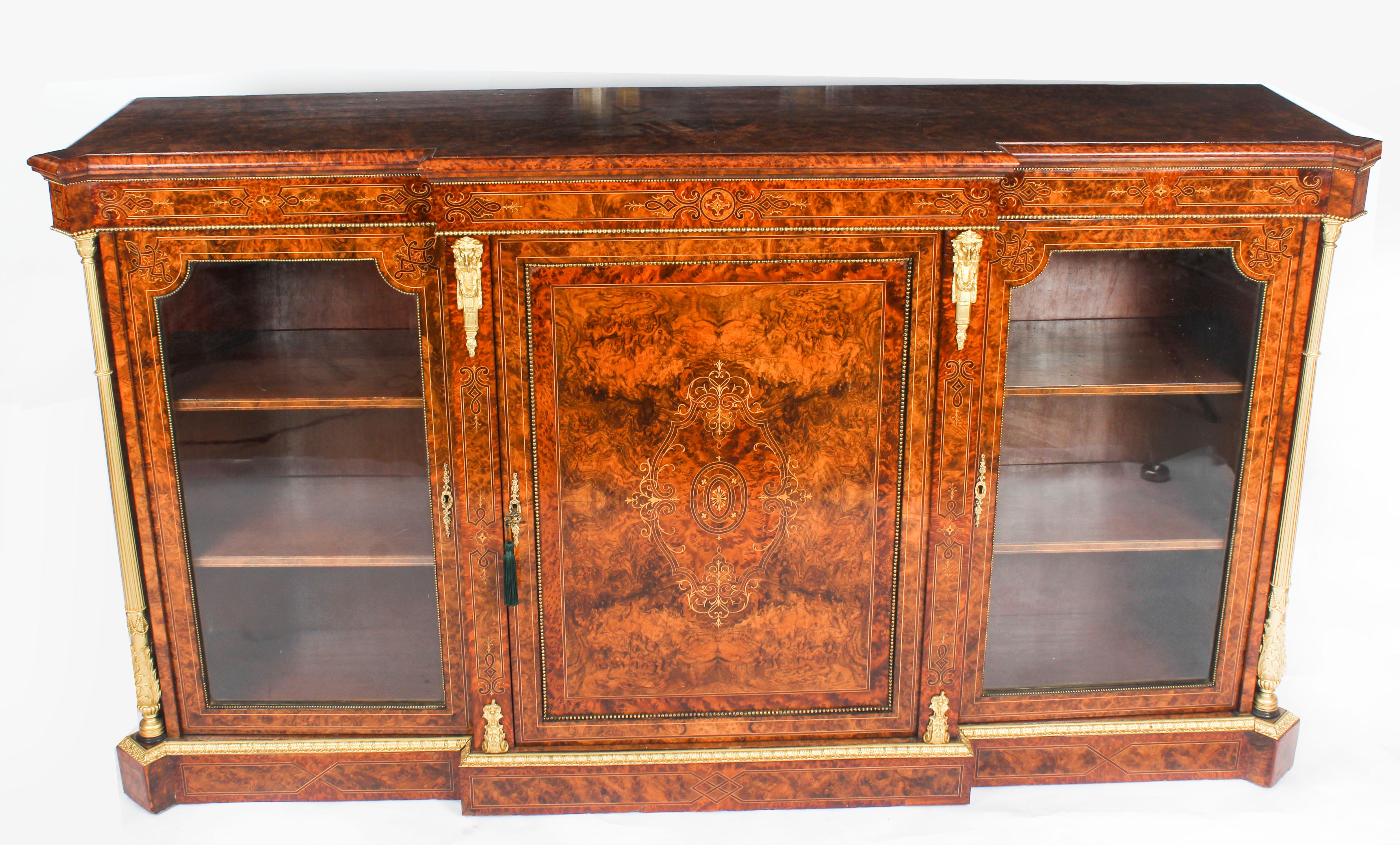 A Victorian inlaid burr walnut credenza embellished with ormolu stylised columns, which bears the stamp of the renowned London cabinet maker and retailer Edwards & Roberts, Circa 1860 in date.
 
This truly superb credenza is ormolu mounted, has
