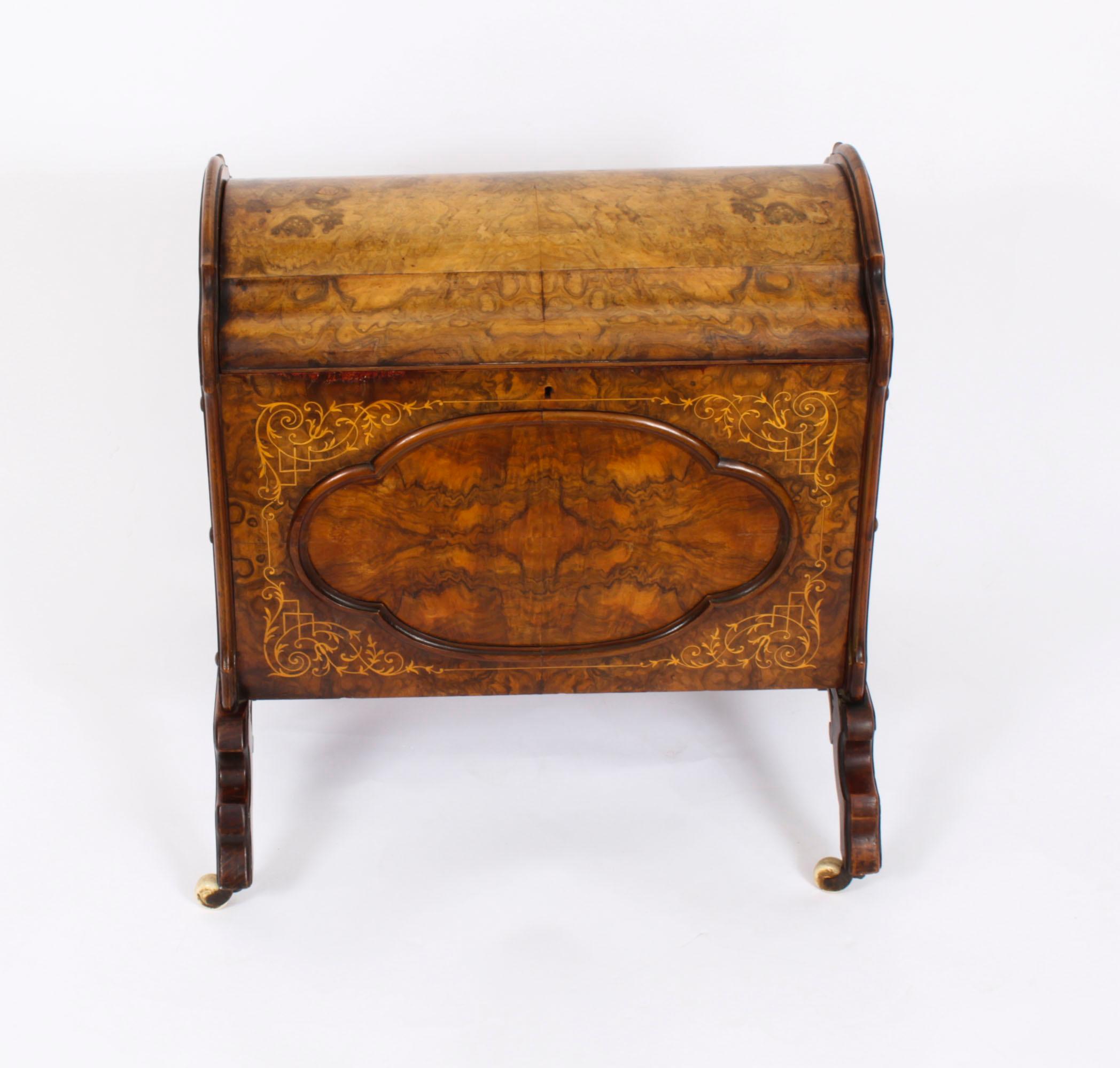 This is a gorgeous antique Victorian burr walnut and marquetry inlaid enclosed  Canterbury circa 1870 in date.
 
The grain of the burr walnut is truly beautiful. It features a hinged top opening to a divided interior. The sides are fitted with 