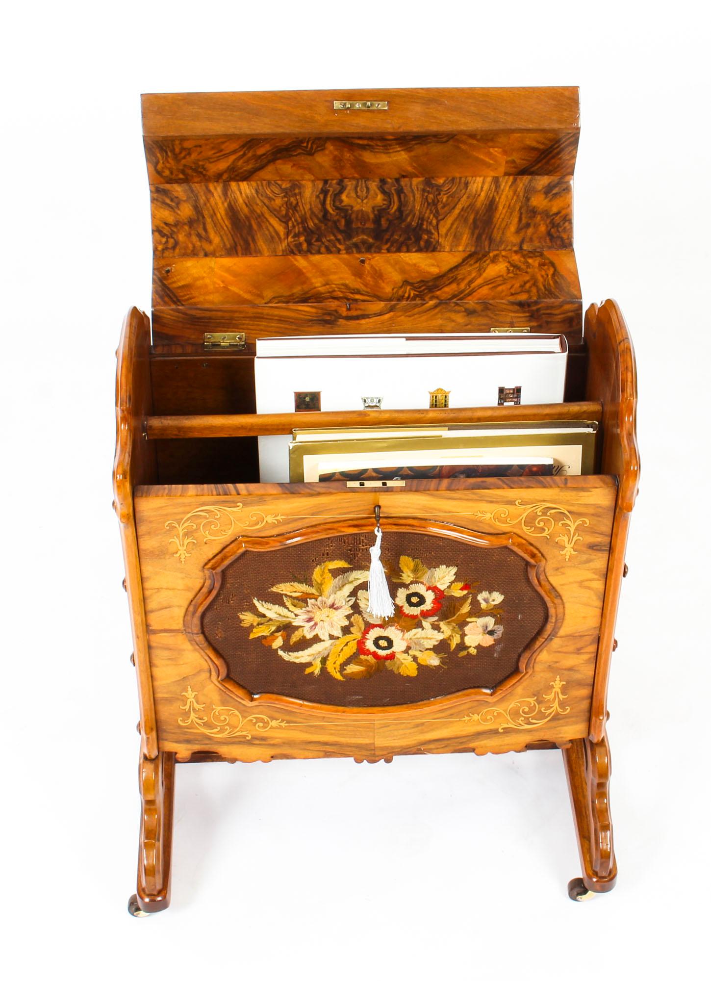 This is a gorgeous antique Victorian burr walnut, marquetry and needlework Canterbury circa 1870 in date.
 
The grain of the burr walnut and the inlaid marquetry are truly beautiful.

It features a hinged top opening to a divided interior, the